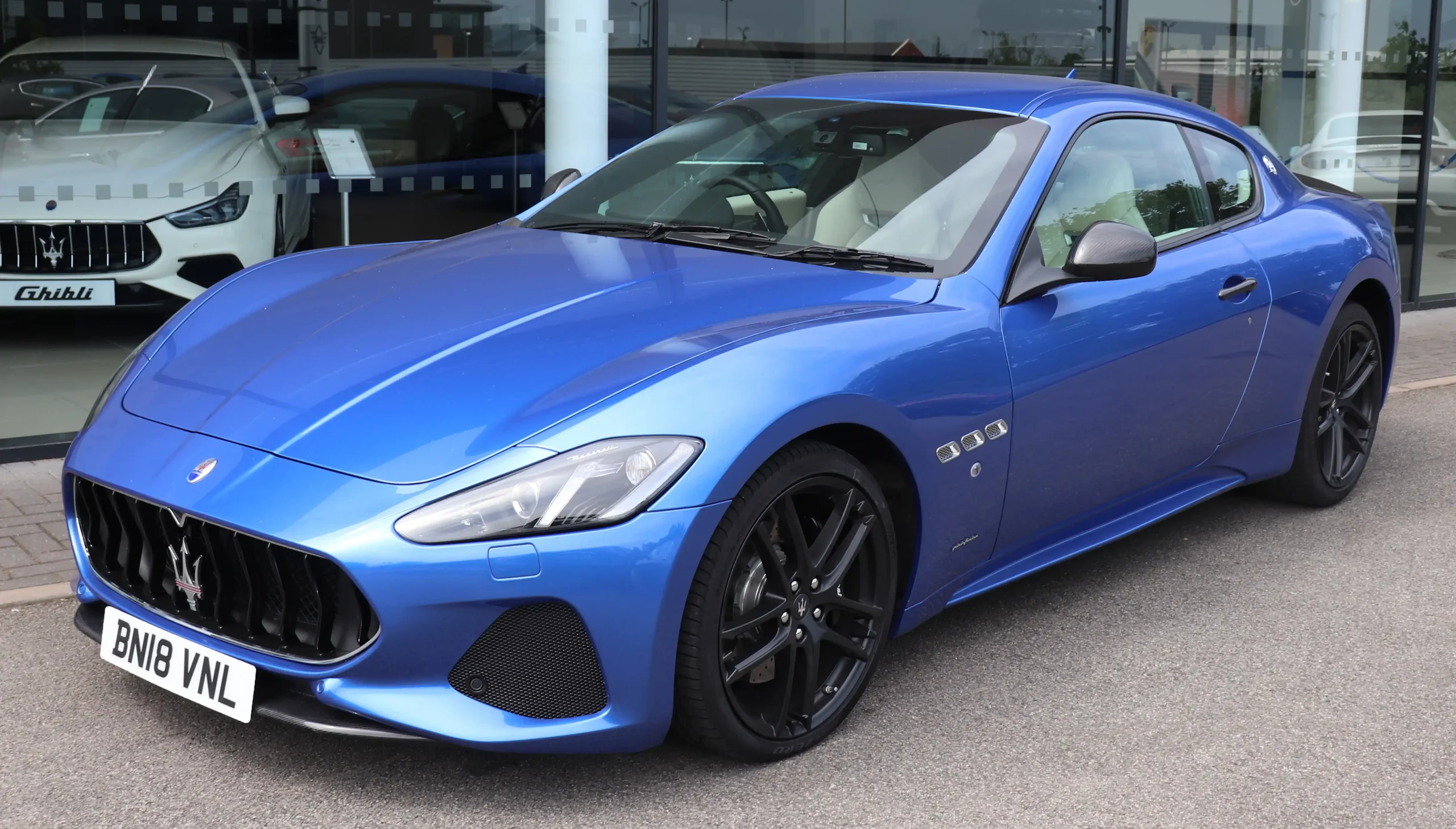 Sleek, silver Maserati GranTurismo parked; luxurious Italian sports car.
