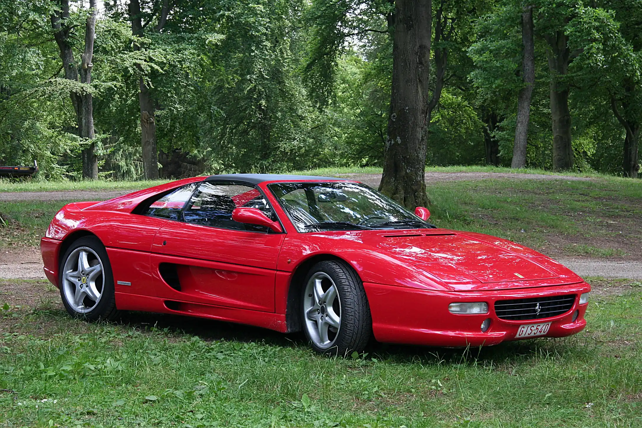 Red Ferrari F355 Spider, sleek and powerful, top down.