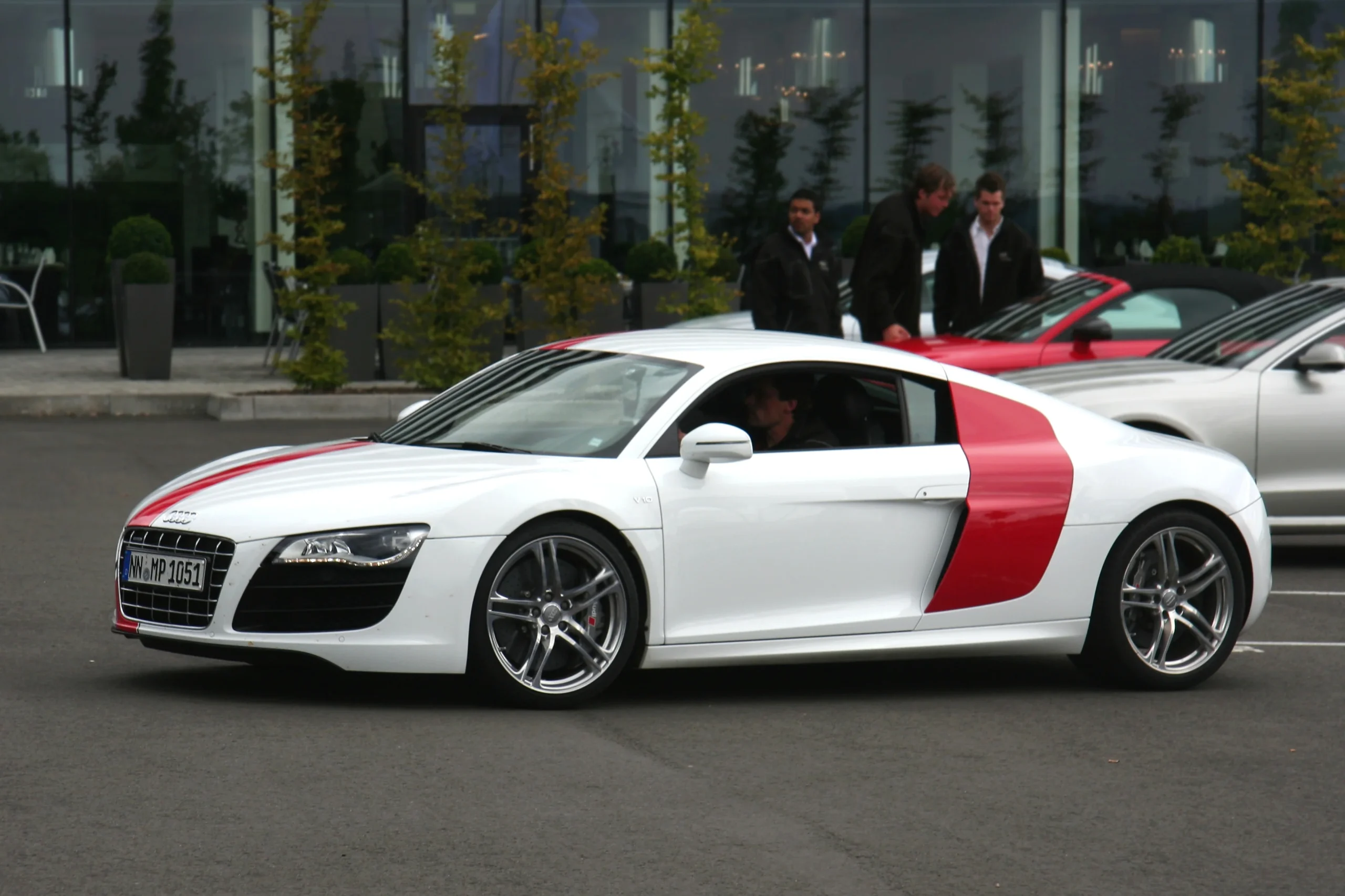 Sleek silver Audi R8 V10, powerful sports car on asphalt.