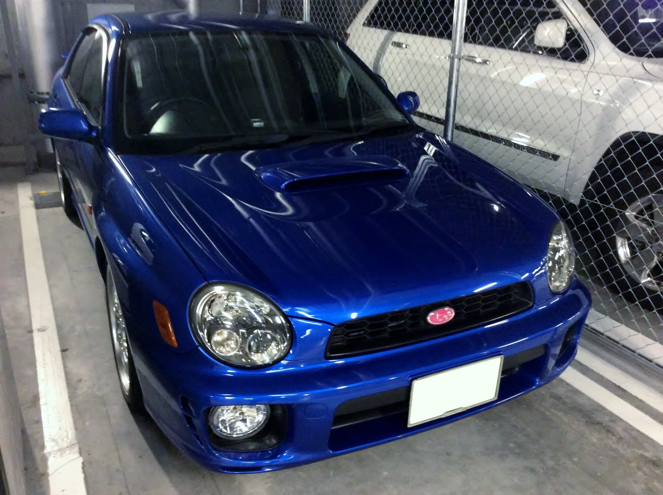 Blue Subaru Impreza WRX STI parked, iconic rally car.