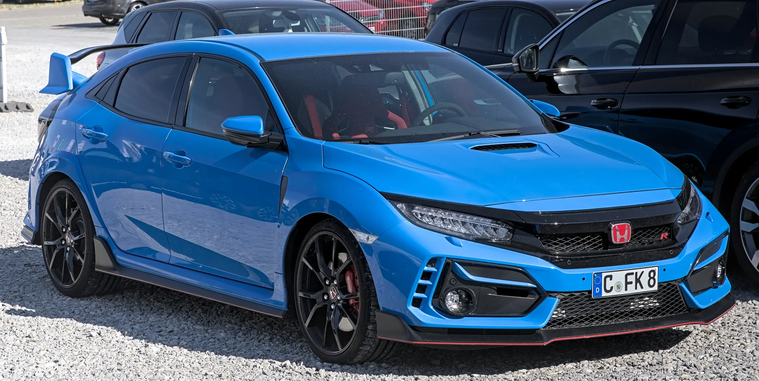 Jet blue Honda Civic Type R parked, showcasing its sporty design