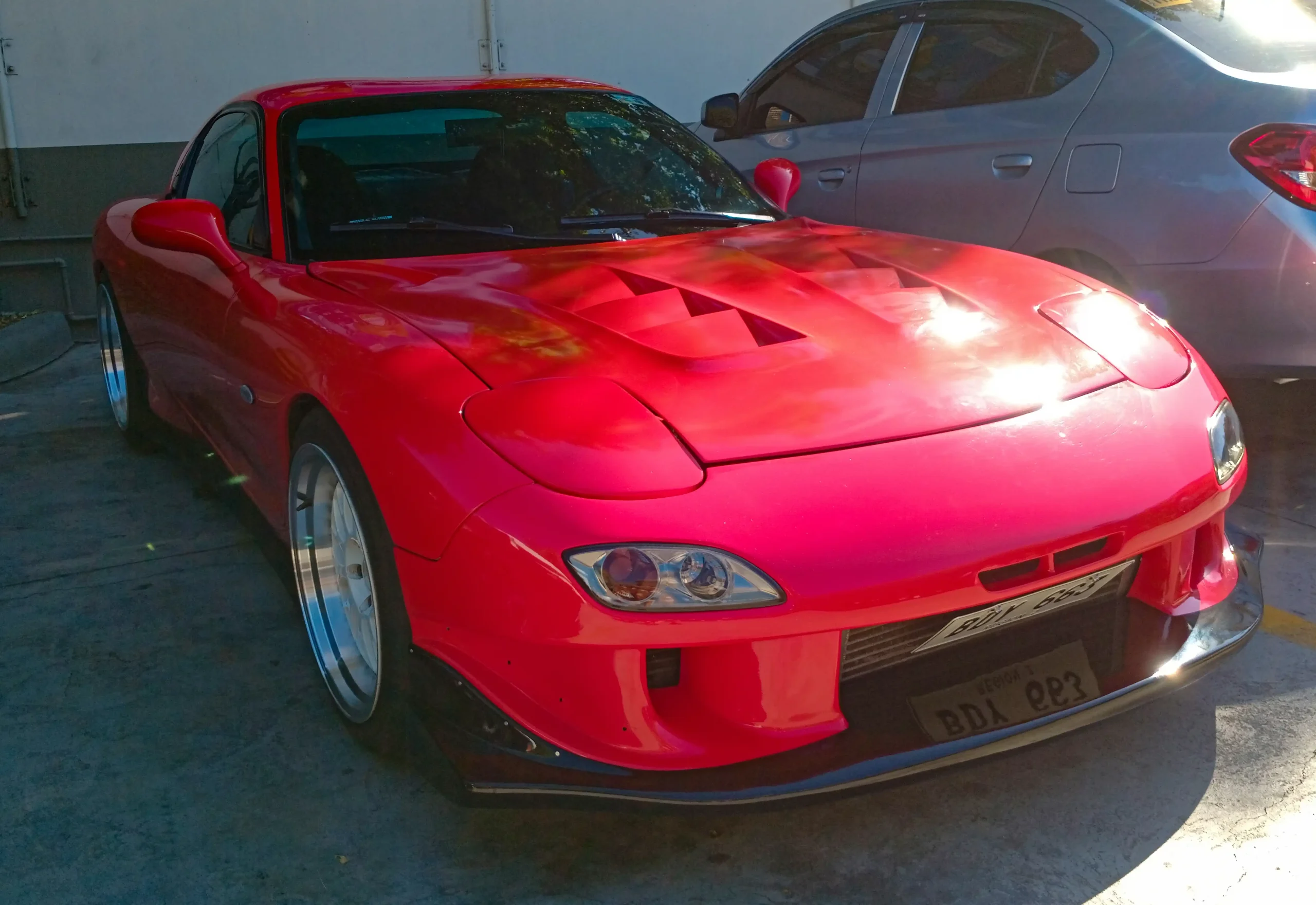 Sleek red Mazda RX-7 FD3S, iconic Japanese sports car.