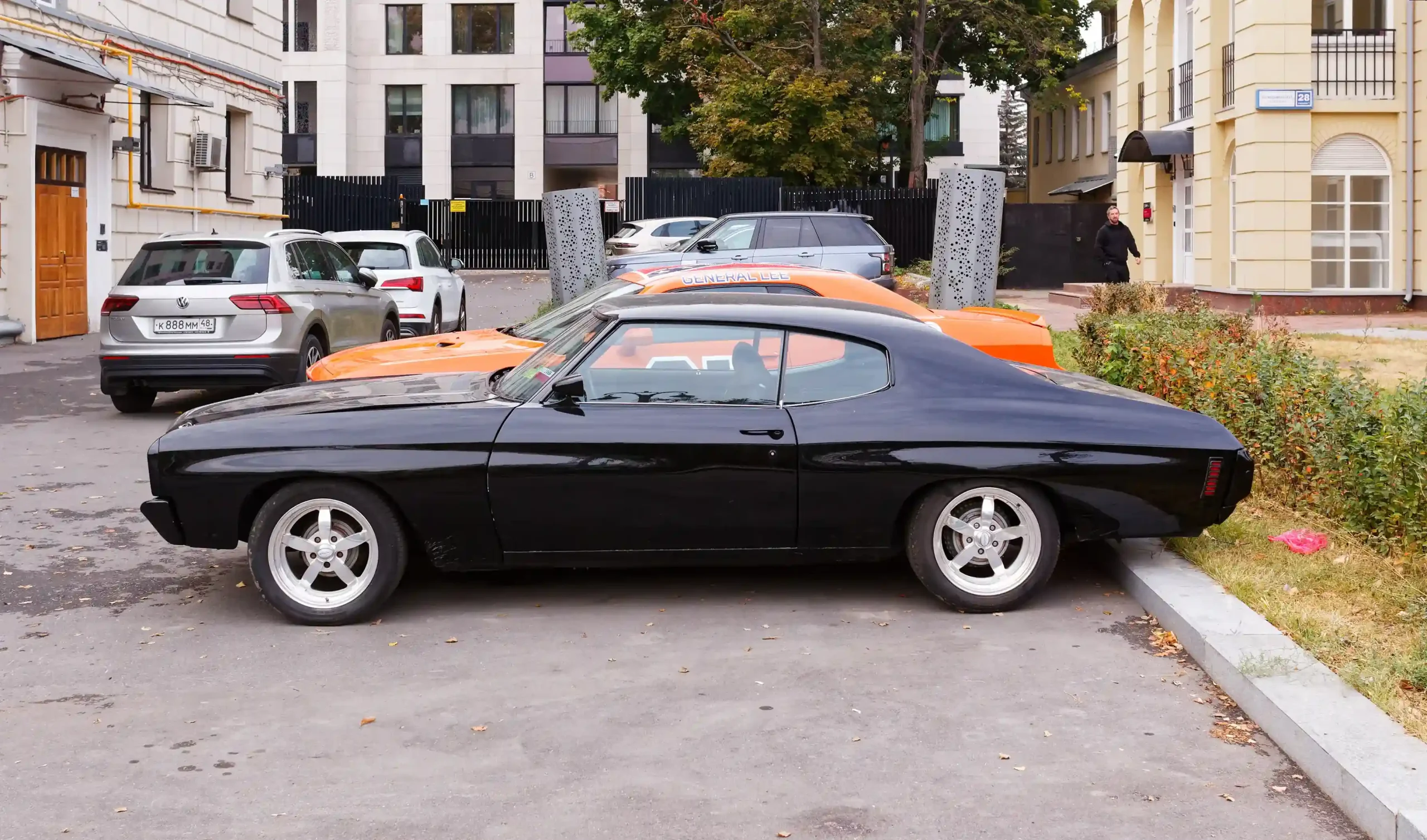 Classic red Chevrolet Chevelle SS muscle car, parked on street.