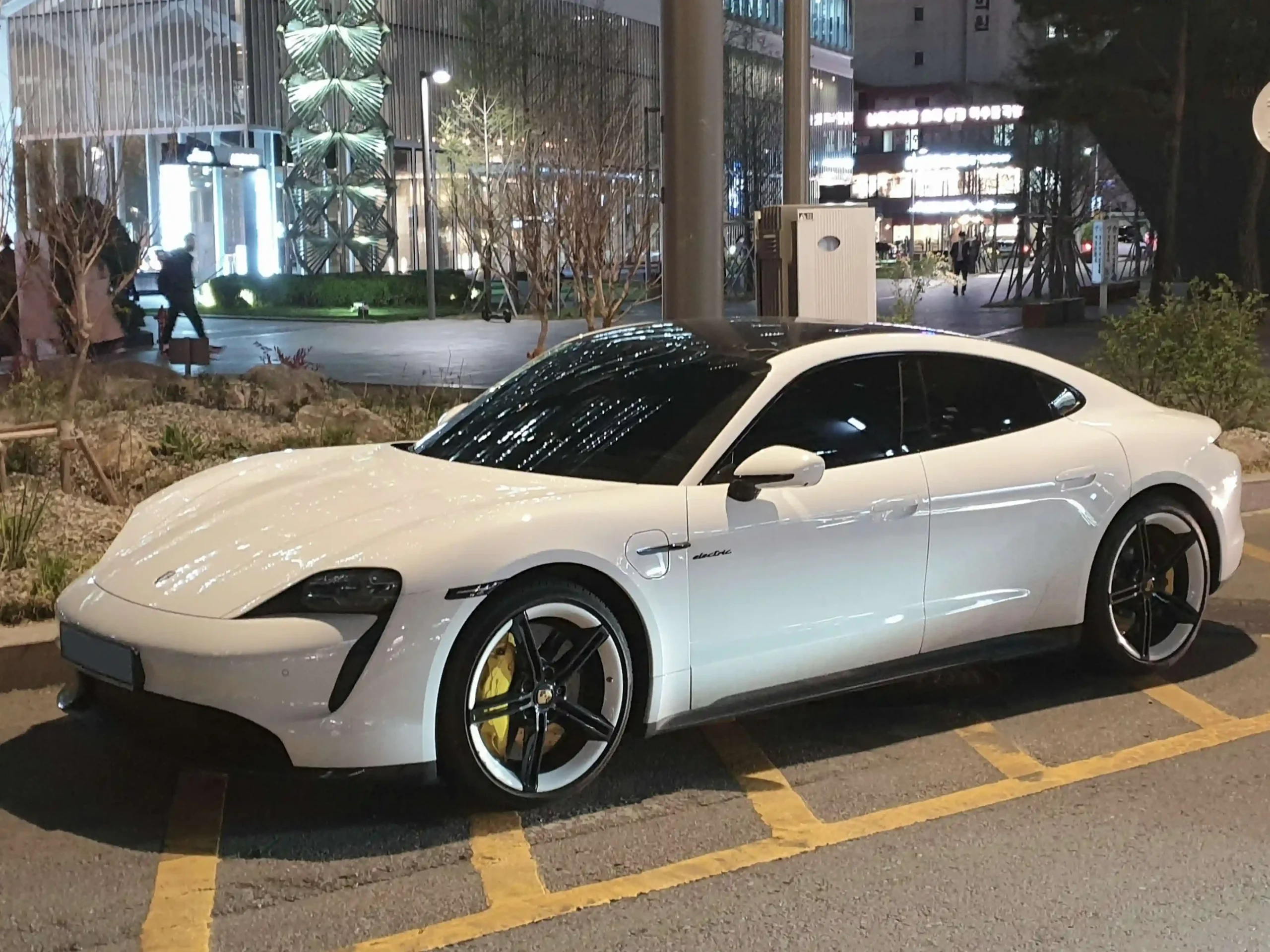 Sleek Porsche Taycan Turbo S electric sports car on display