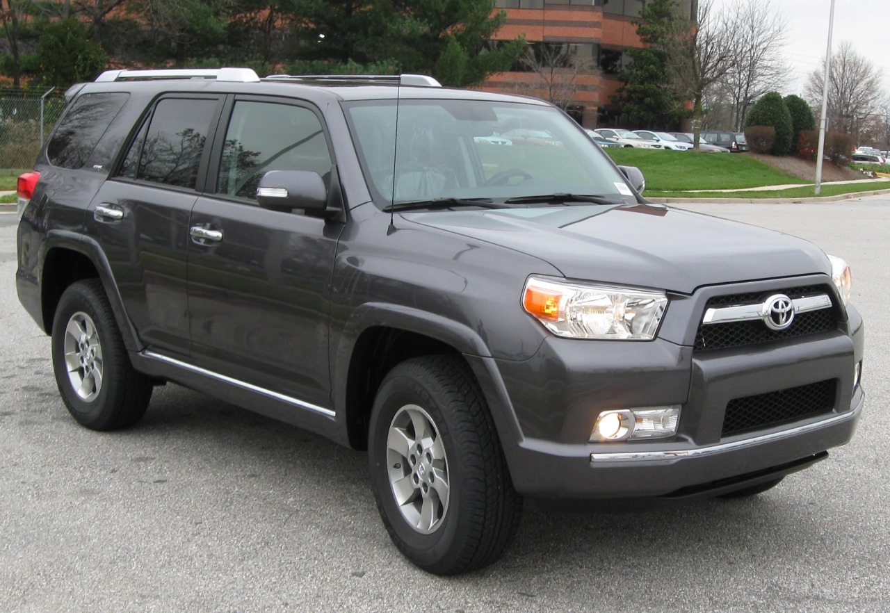 Silver Toyota 4Runner SUV parked on a sunny, off-road trail.