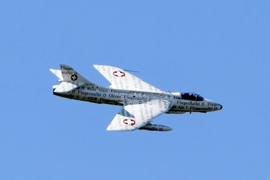 Hunter, aiming a bow and arrow, focused and determined outdoors.