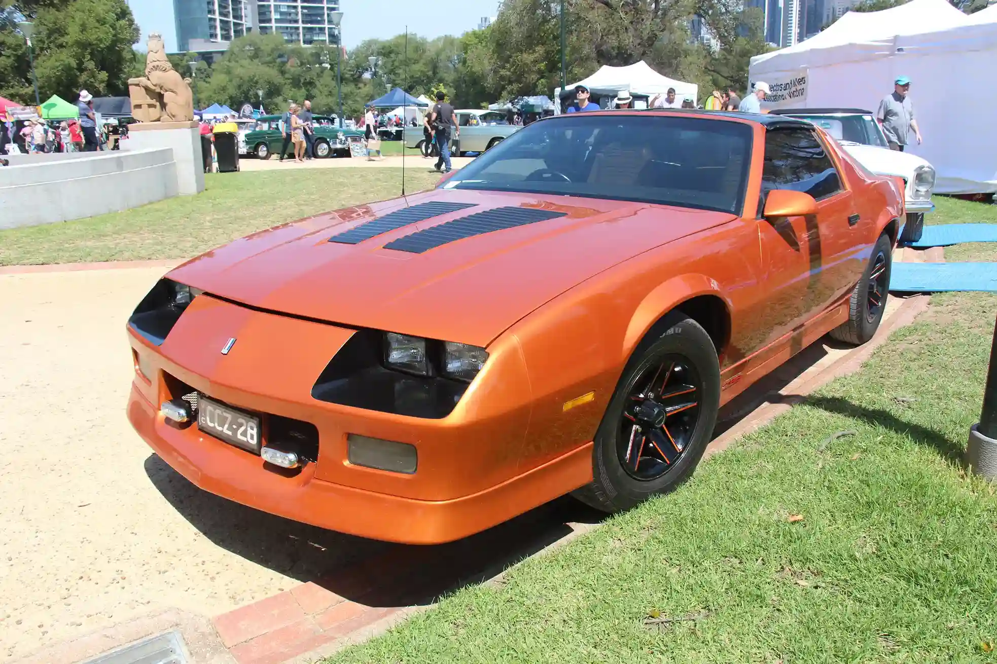 Red 1985 Chevrolet Camaro Z28 parked, showcasing classic 80s styling