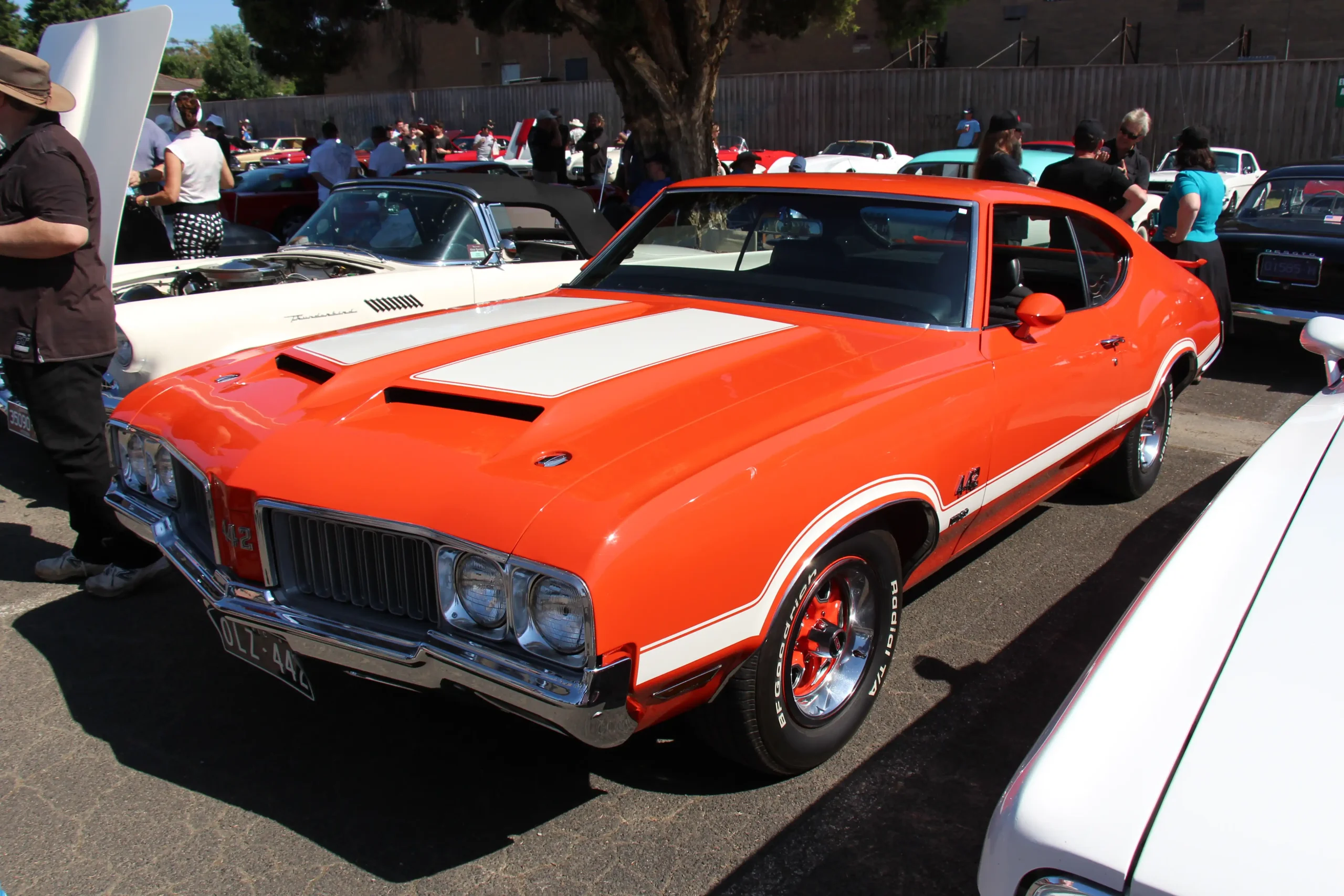 Crimson 1970 Oldsmobile 442 W30 muscle car with a black hood.