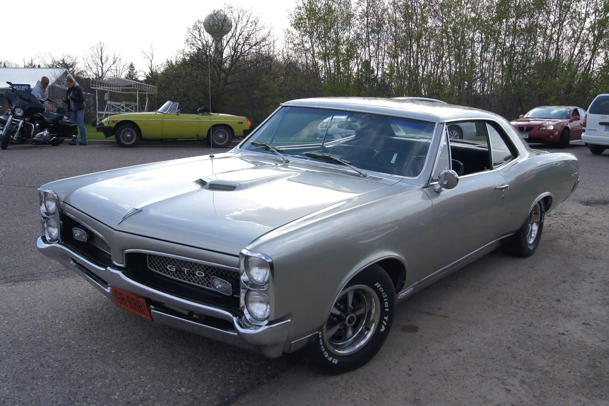 Sleek 1967 Pontiac GTO, classic muscle car, side view.