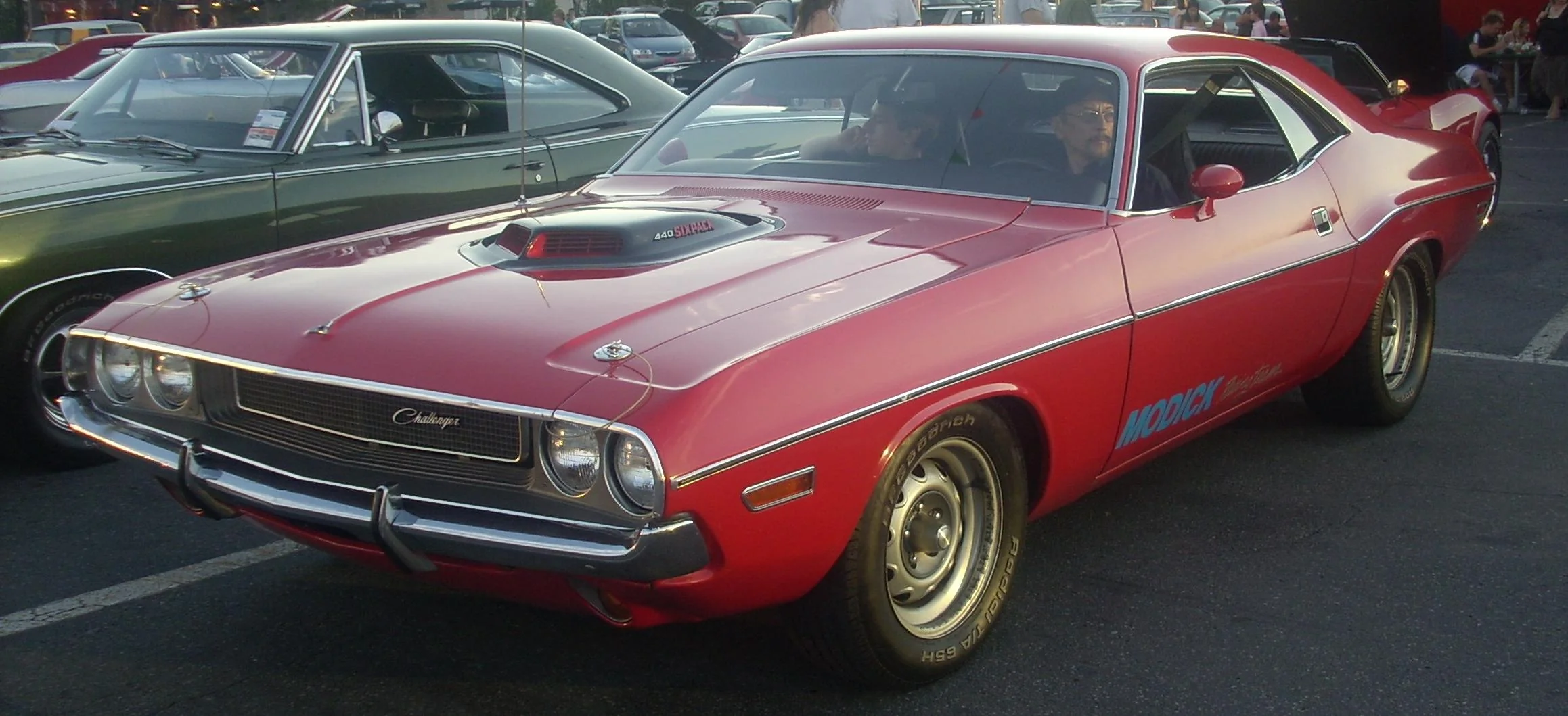 Orange Dodge Challenger parked in front of the giant orange Gibeau Orange Julep.