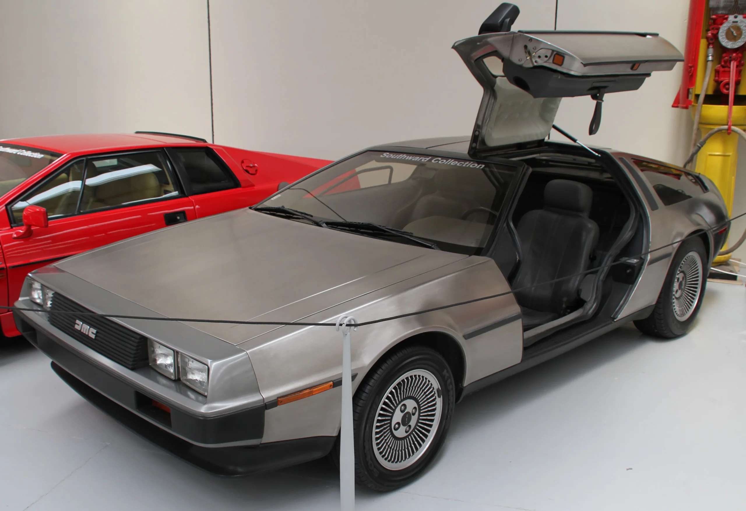 Silver DeLorean DMC-12 car parked, recognizable from "Back to the Future."