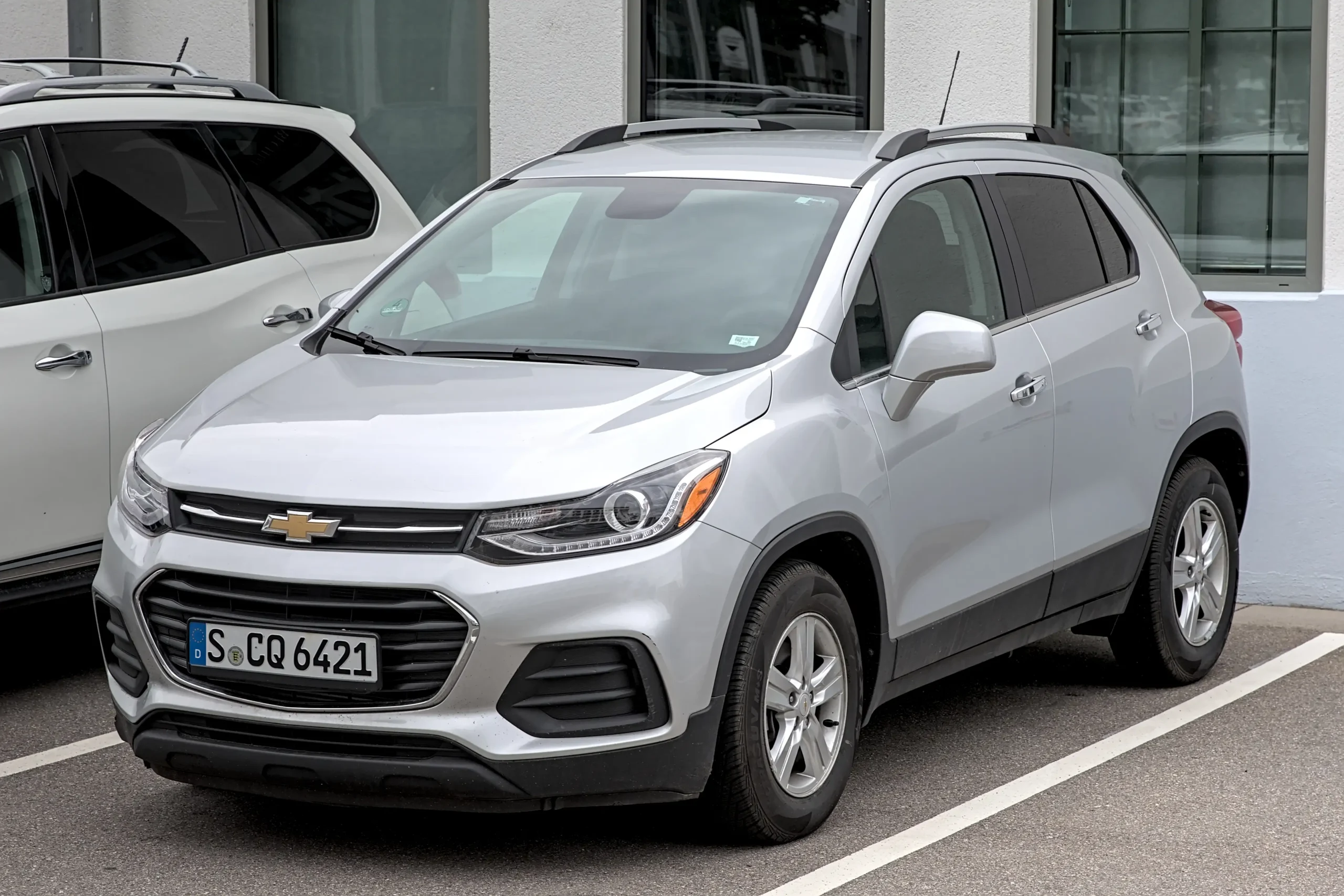 Chevrolet Trax SUV parked on a sunny street, showcasing its design.
