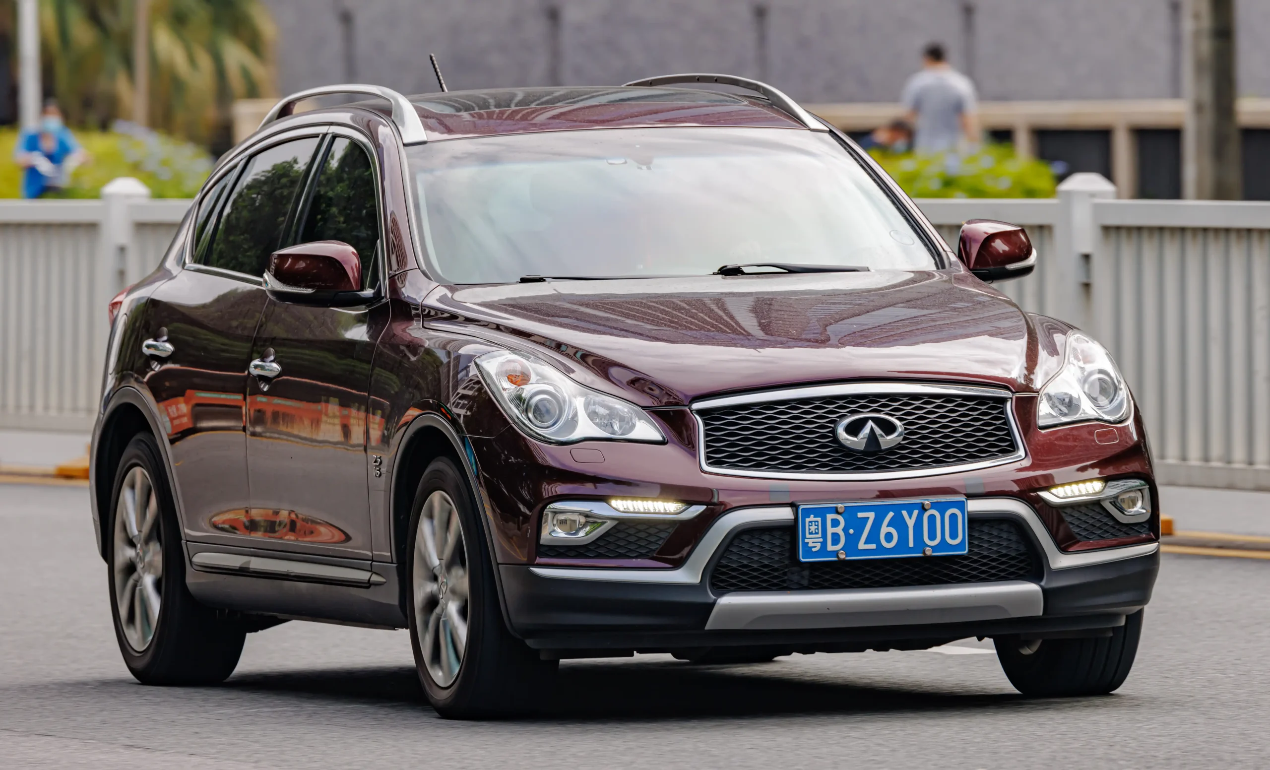 Sleek silver Infiniti QX50 parked, showcasing its modern SUV design.