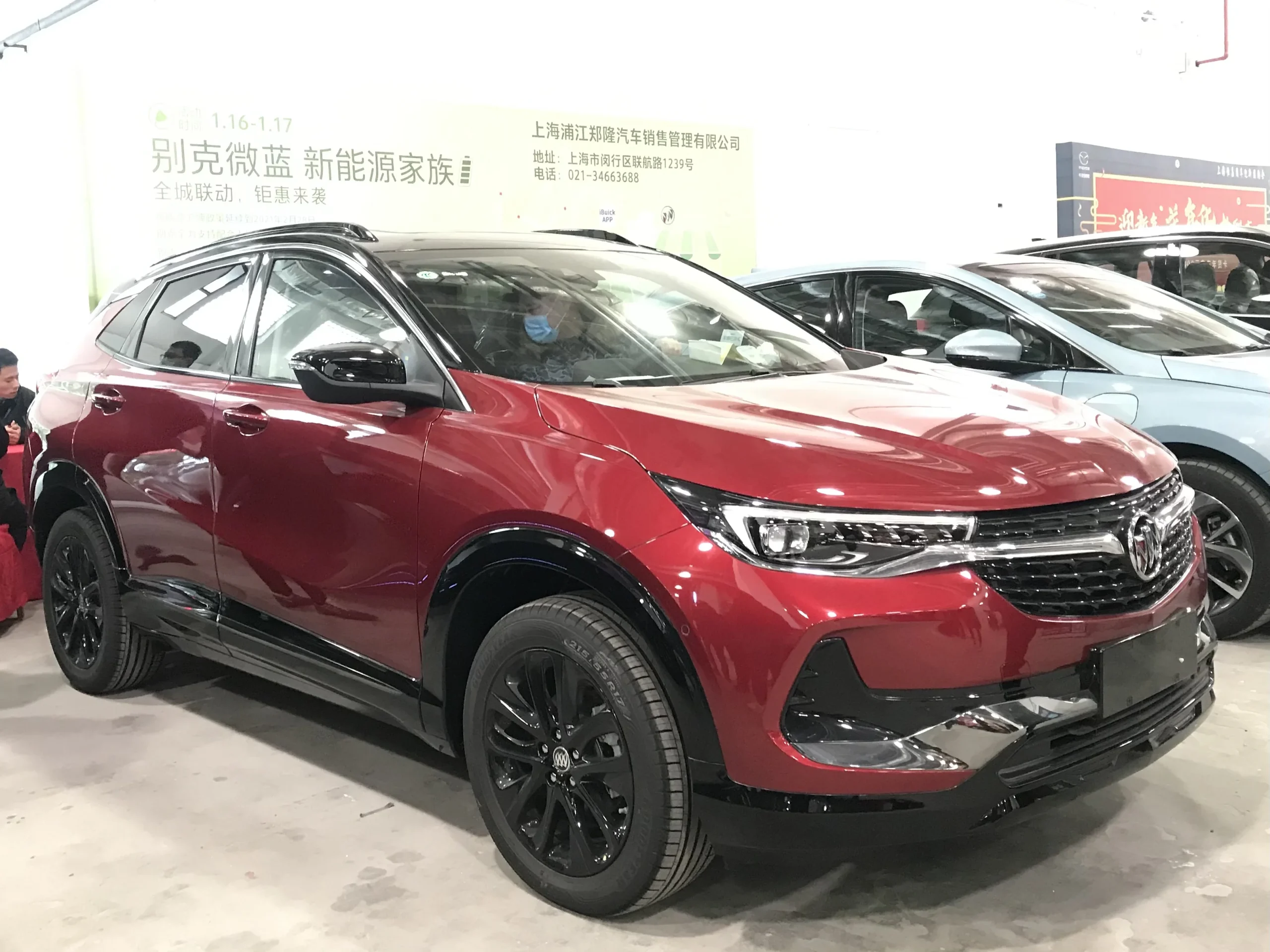 Red Buick Encore parked on a sunny suburban street.
