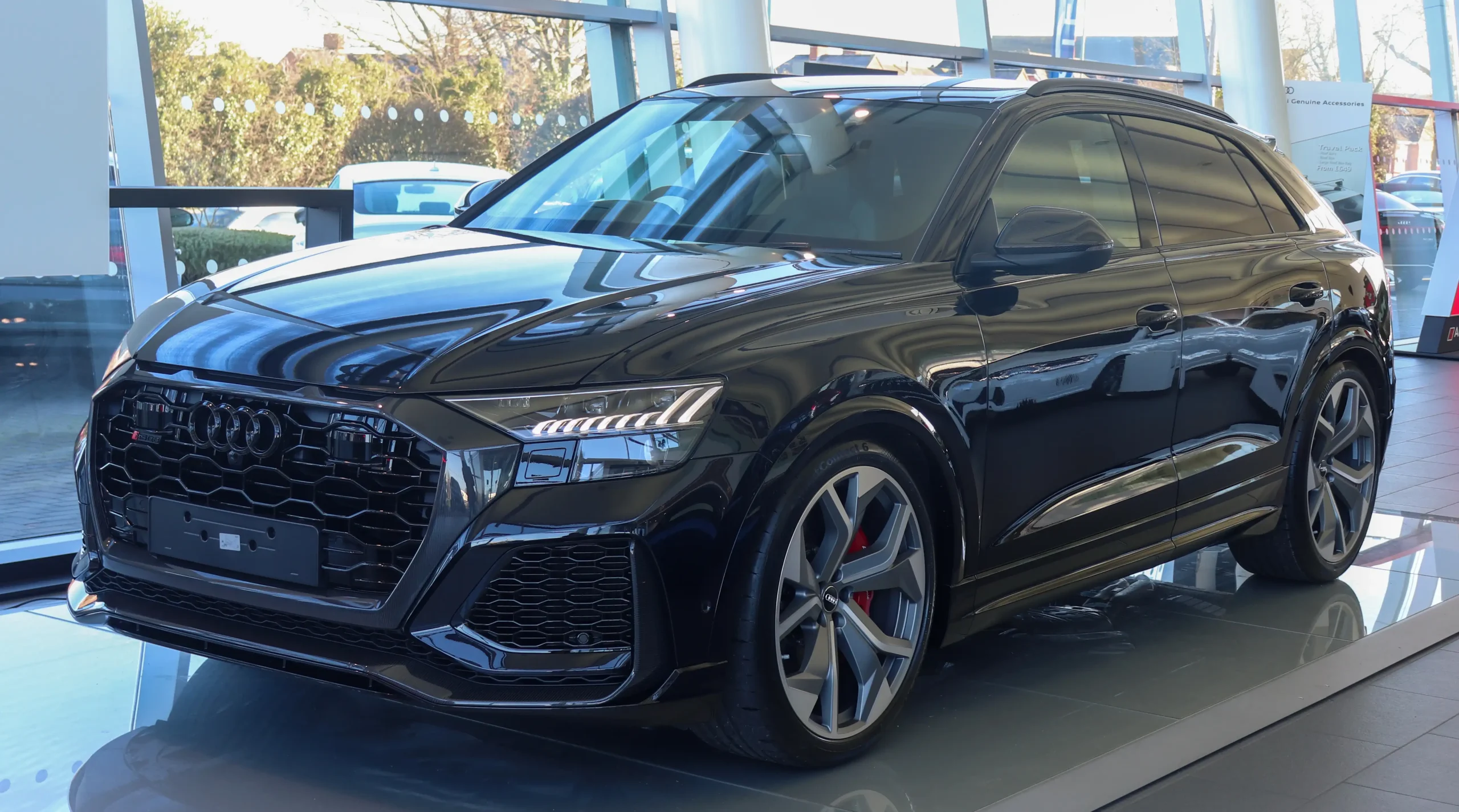 Red Audi RS Q8 parked, showcasing its aggressive design.