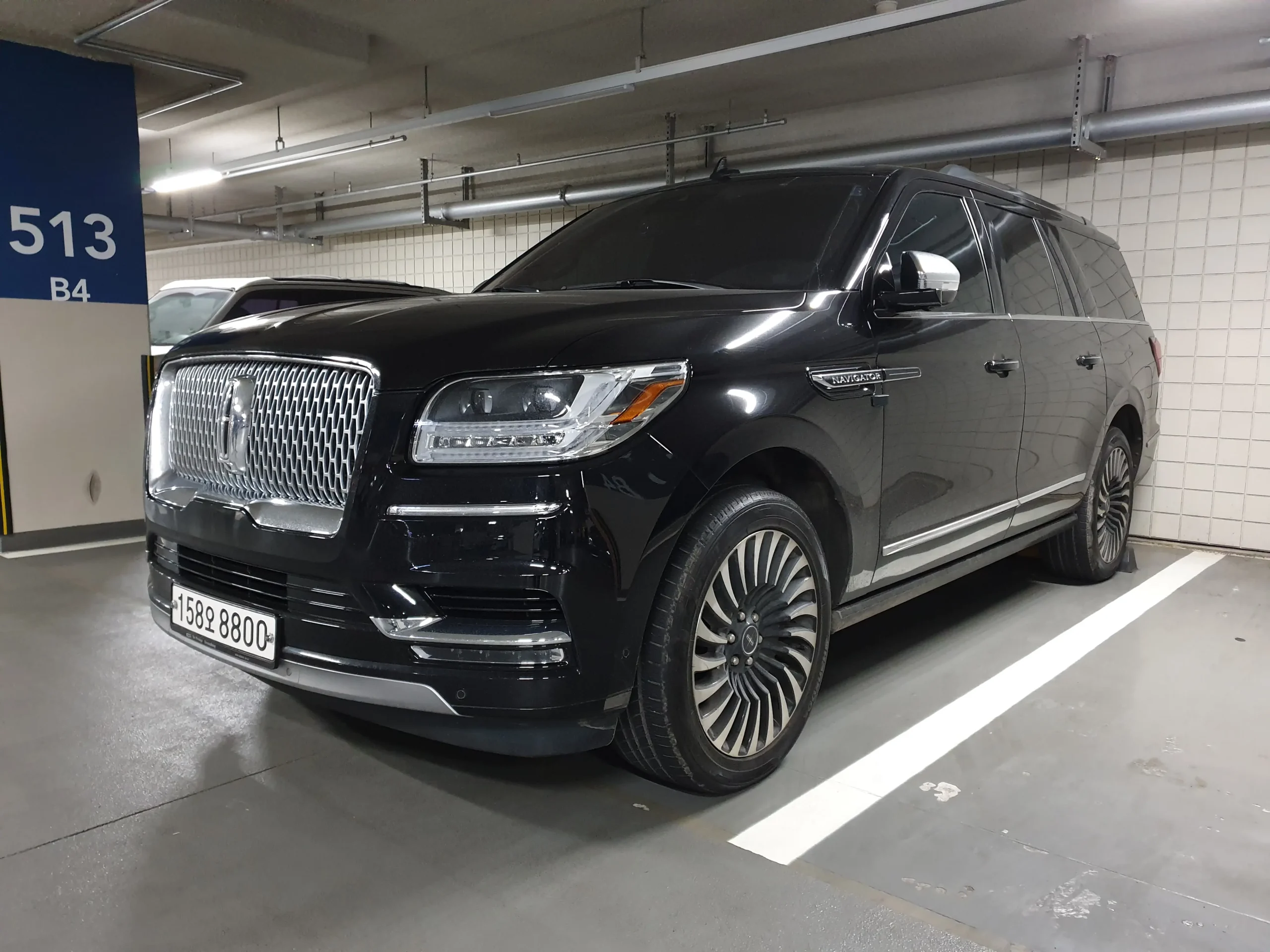 Luxurious black Lincoln Navigator Black Label SUV, gleaming and powerful.