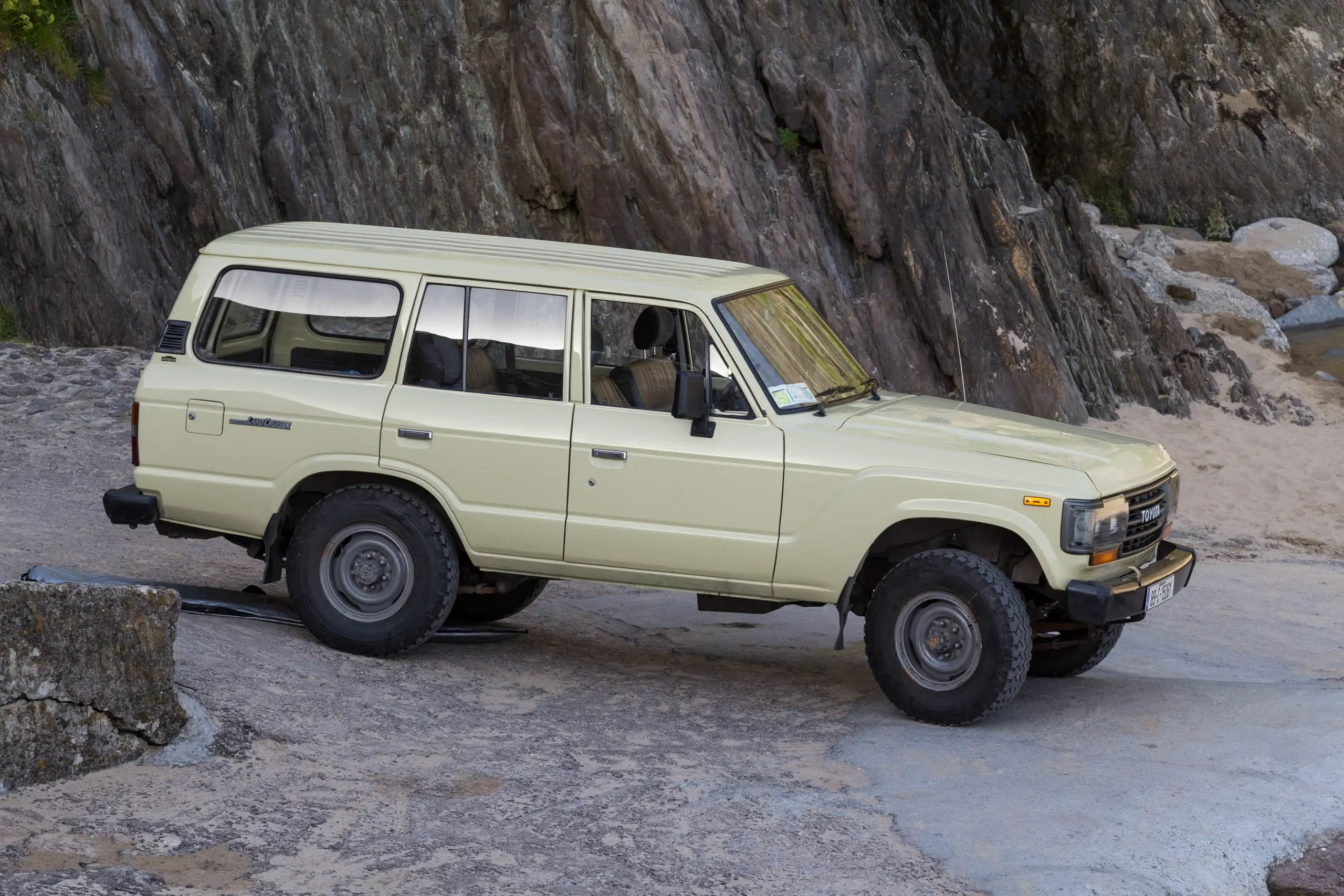 Silver Toyota Land Cruiser parked off-road, ready for adventure.