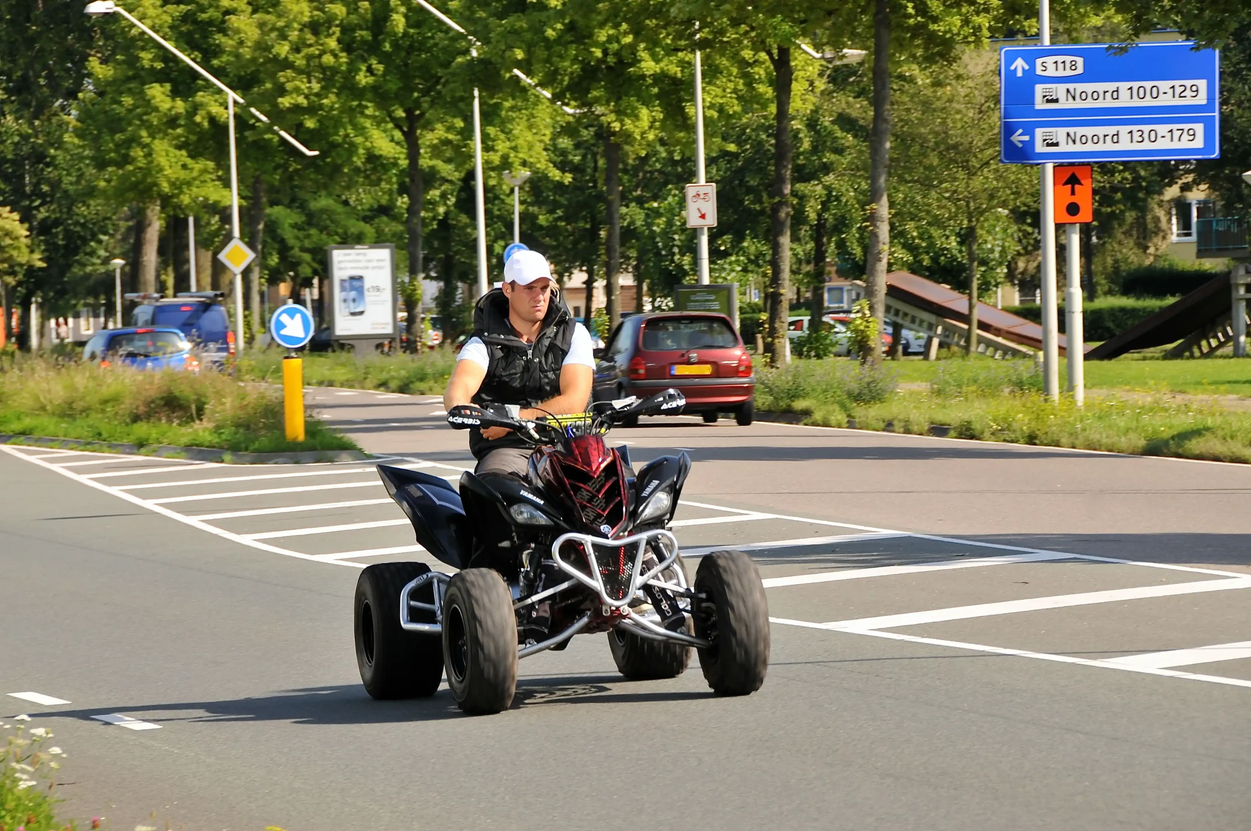 Yellow Yamaha quad parked on a dirt road, ready for adventure.