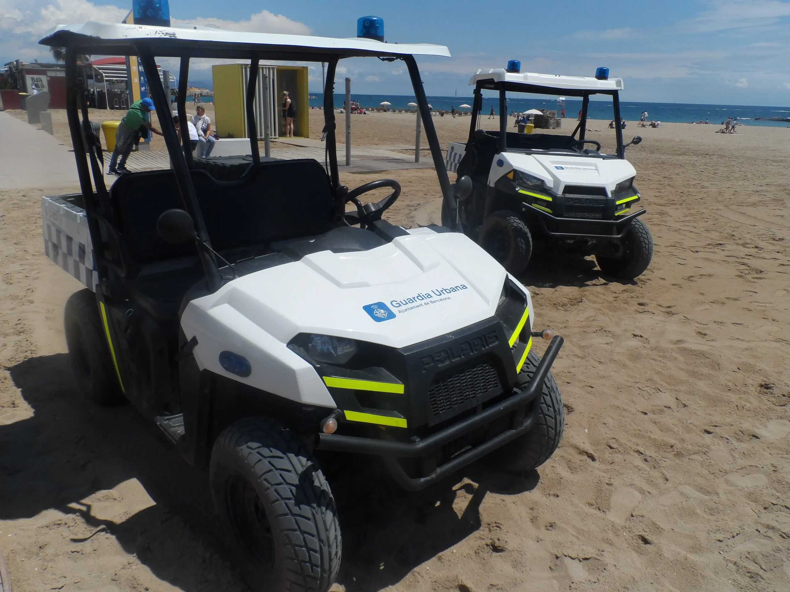 Bright orange dune buggies speeding across a sandy desert landscape.