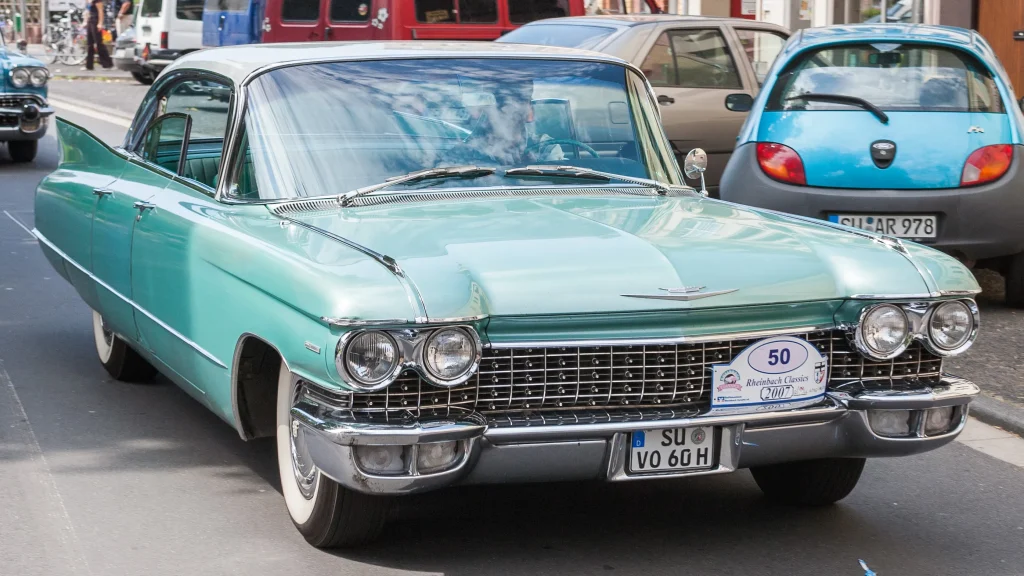 Sleek Cadillac car, chrome accents, parked on a sunny street.