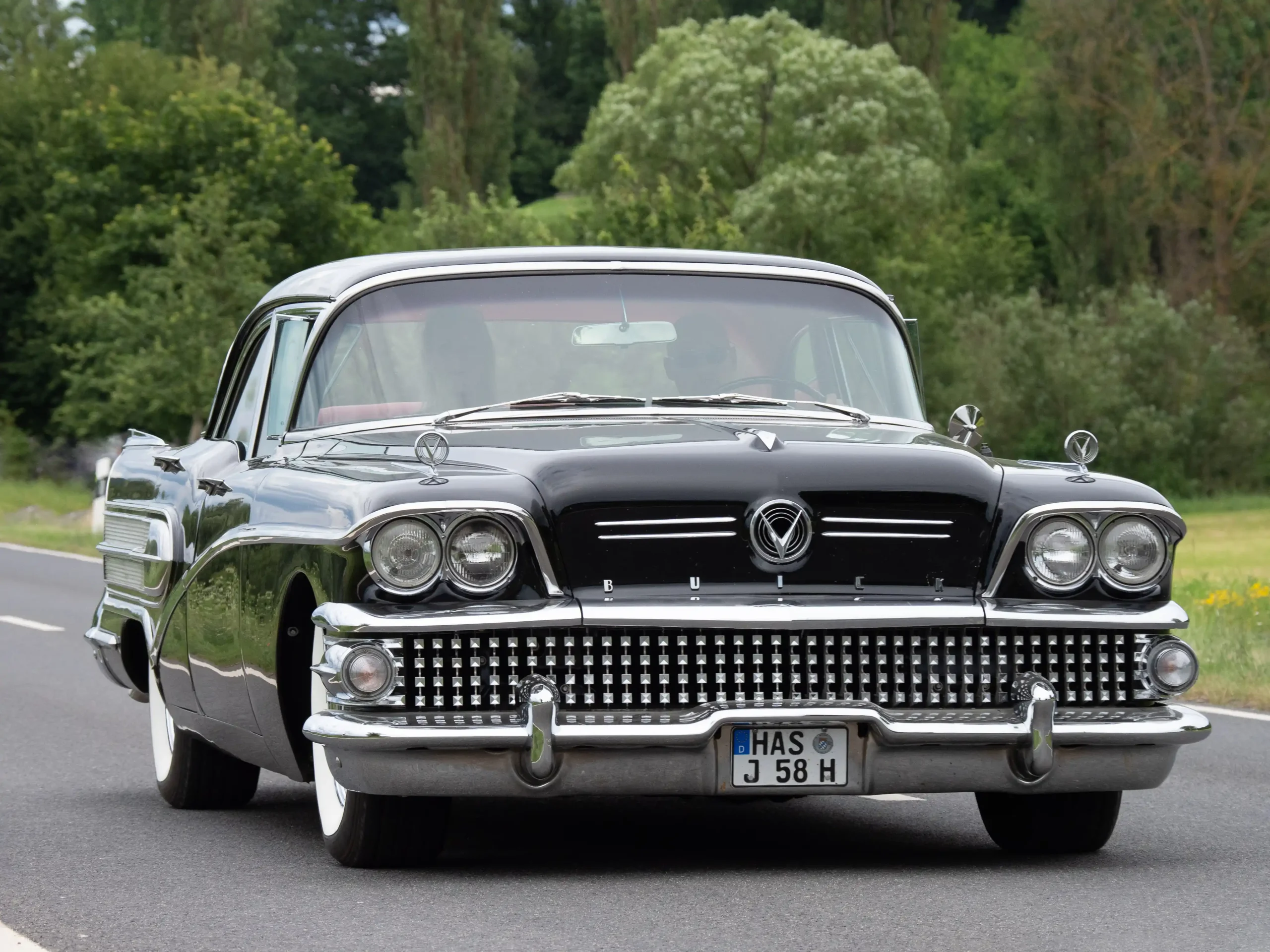 Classic Buick car, gleaming chrome, vintage Americana road trip.
