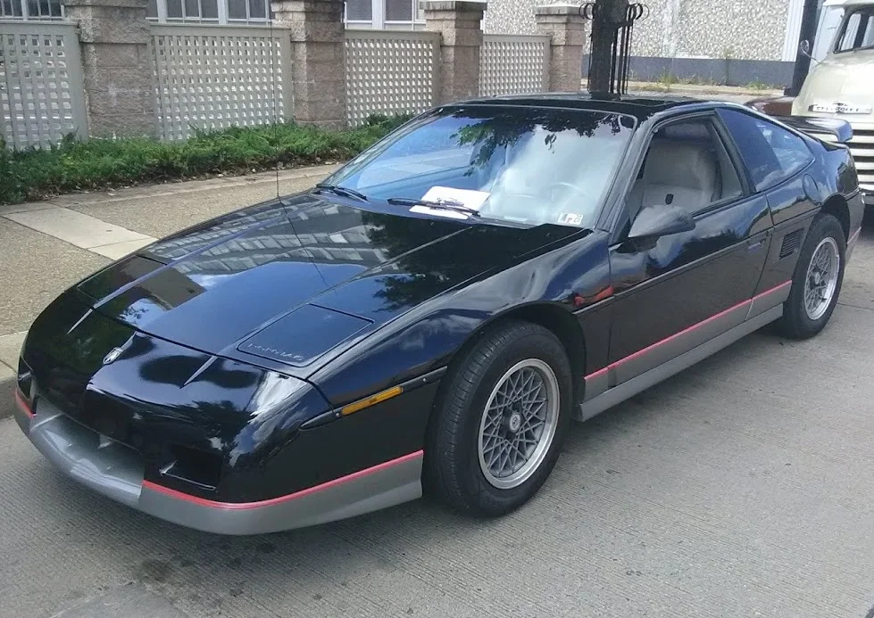 Sleek 1988 Pontiac Trans Am parked on a sunny street