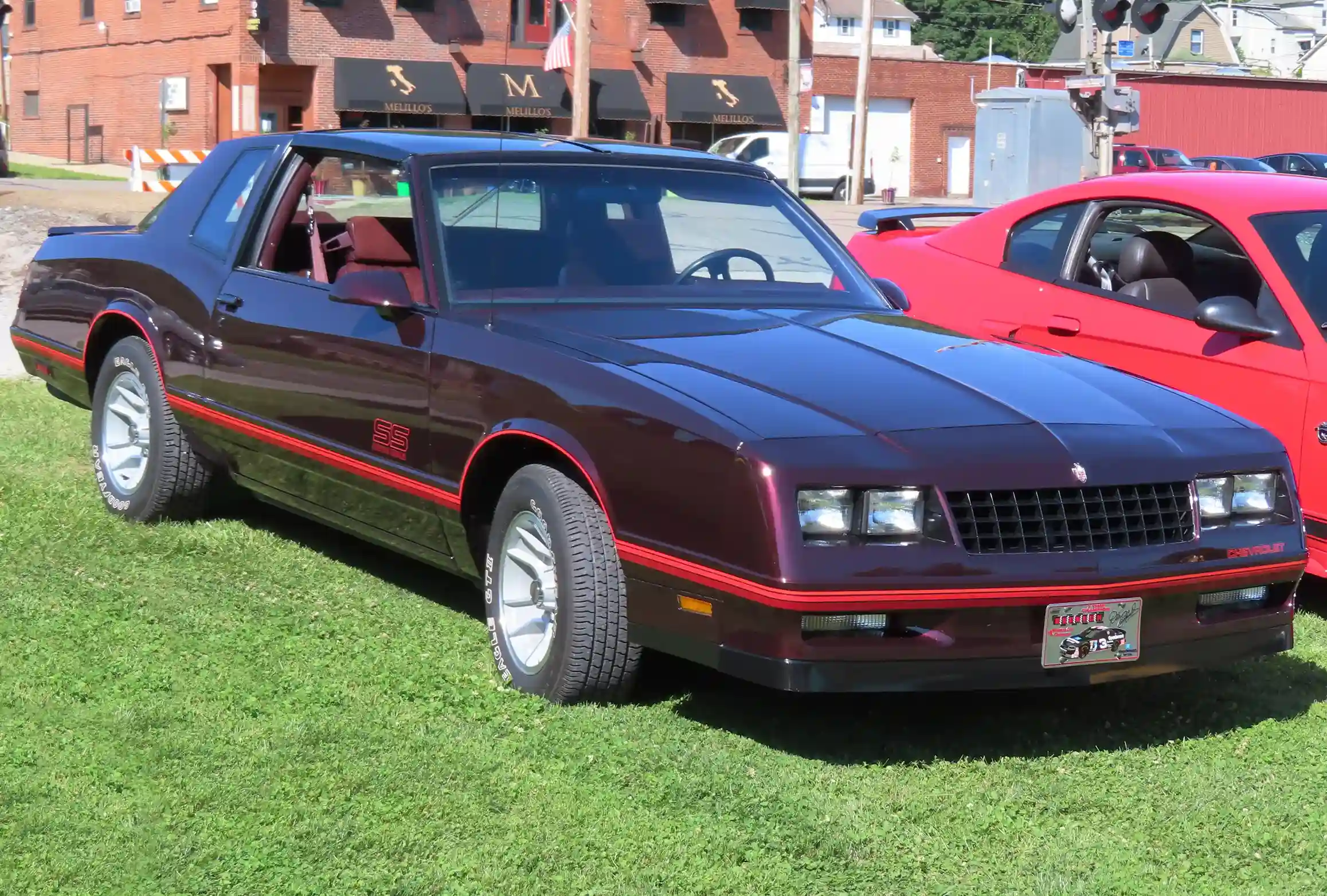 Red Chevrolet Monte Carlo SS parked on a sunny street