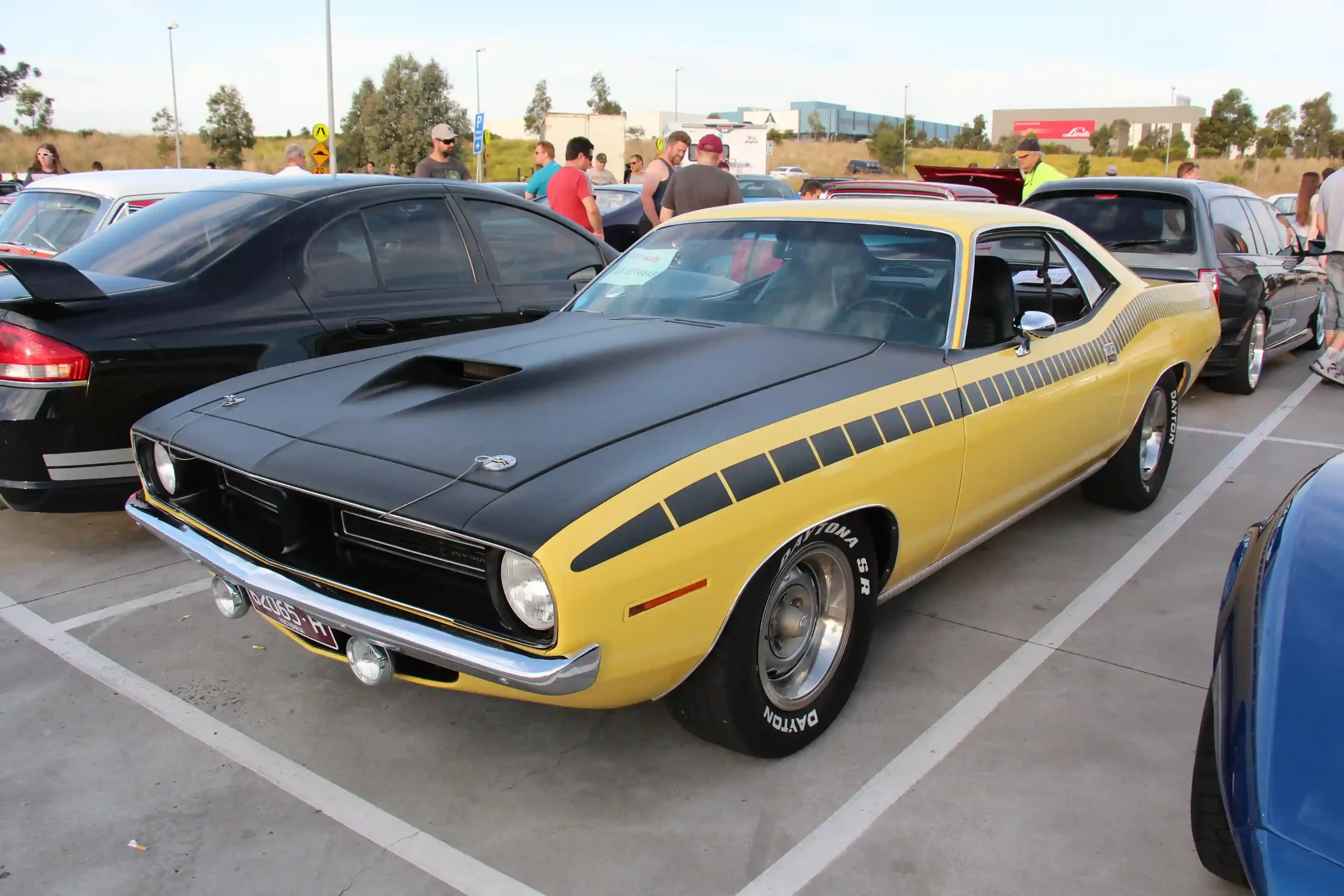 Bright orange 1970 Plymouth AAR Cuda 340 with black racing stripes.
