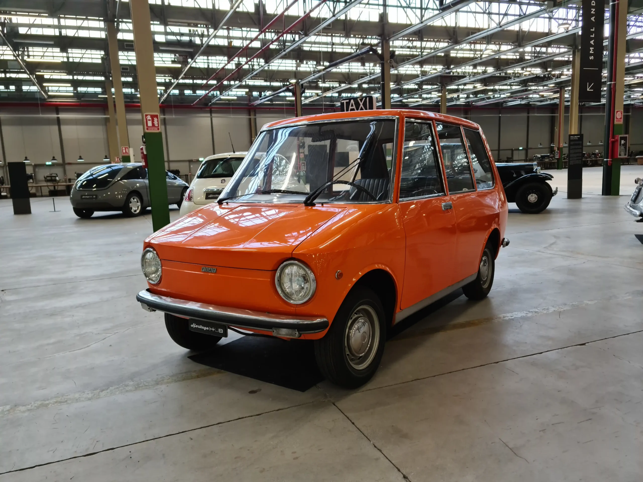 Small Fiat city taxi, likely in Europe, waits for a fare.