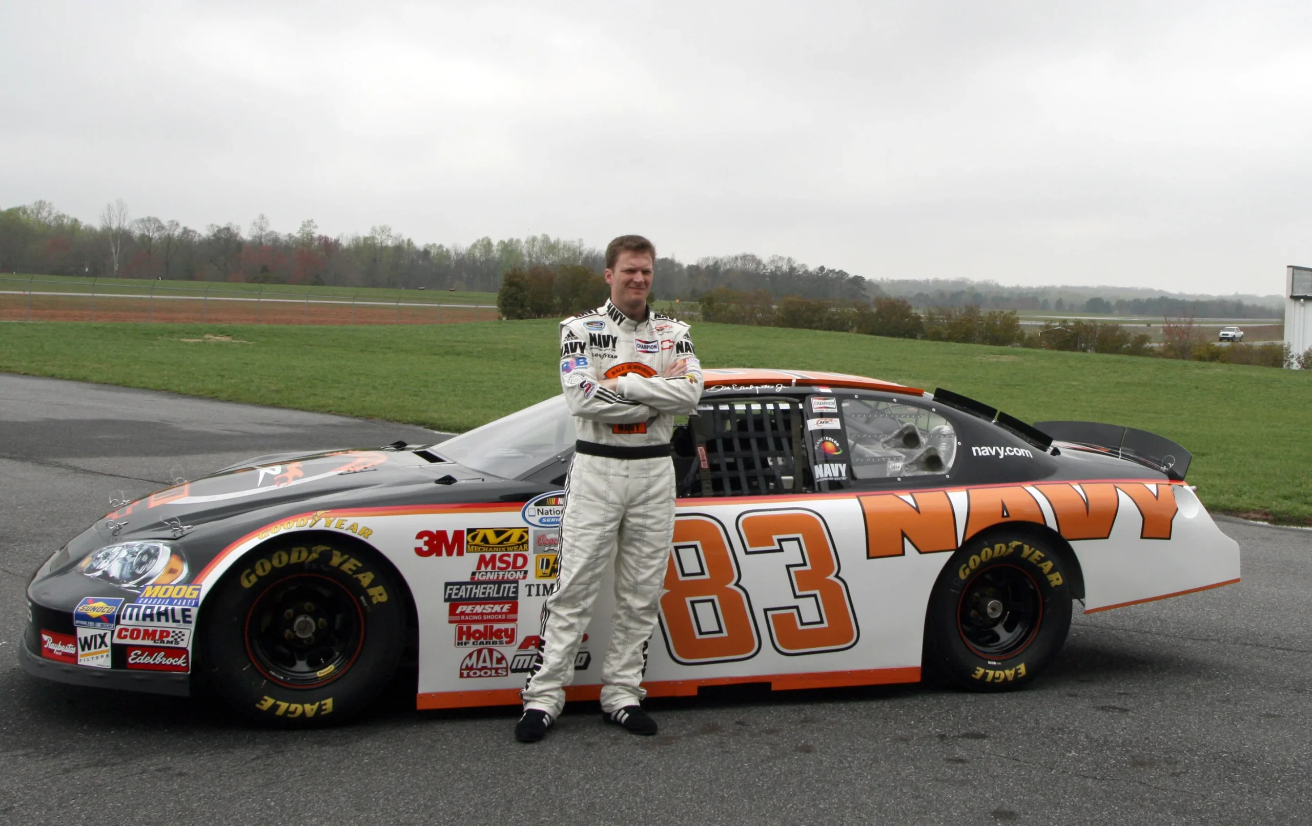 Dale Earnhardt Jr. posing with his Nationwide Series No. 83 racecar.