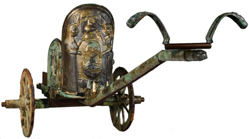 Gold-covered chariot relief with intricately detailed figures and classical Roman style.

