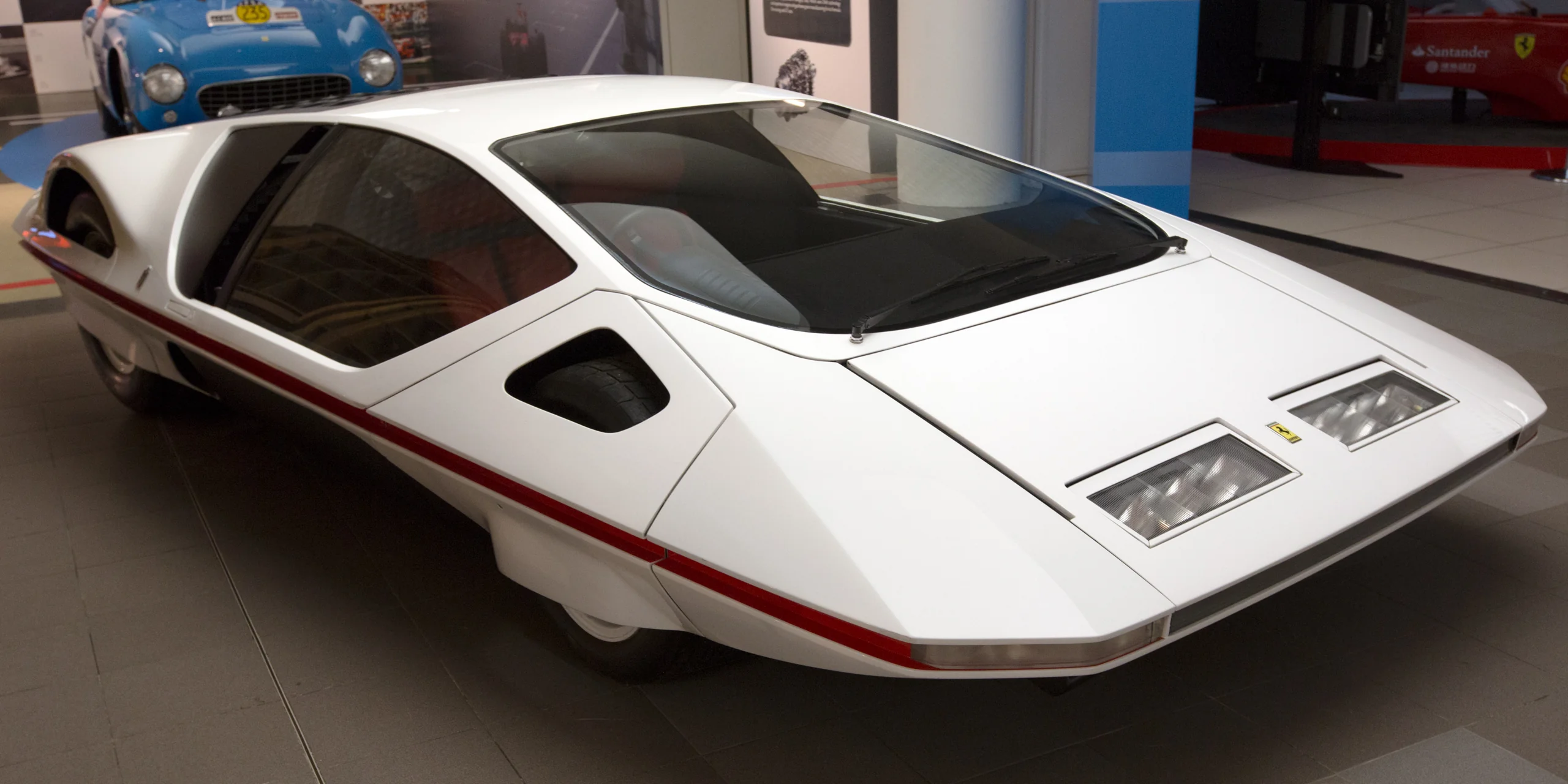 Futuristic wedge-shaped Ferrari Modulo concept car on display, sleek and low.