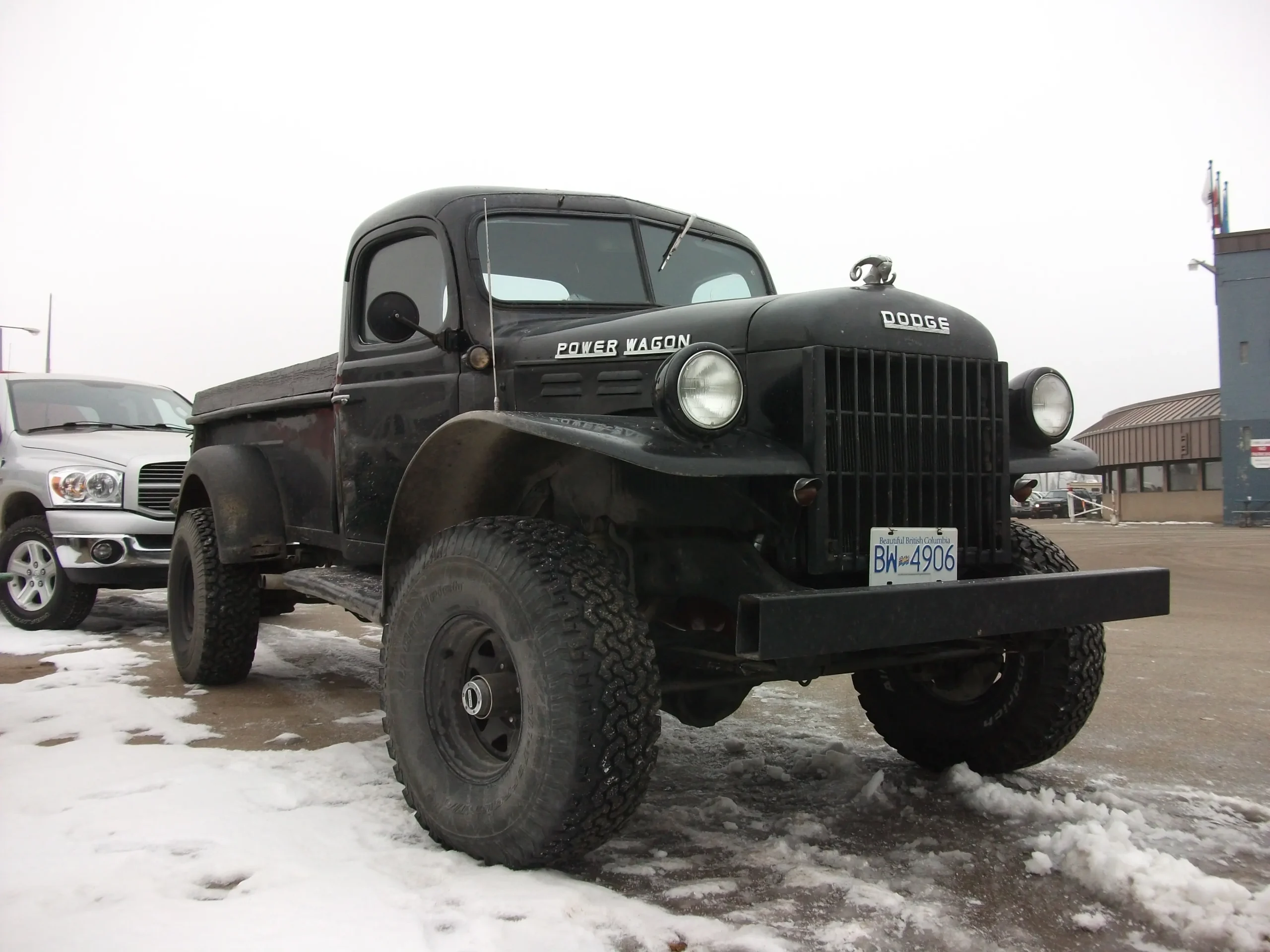 Vintage Dodge Power Wagon on a dirt road, classic off-roader.

