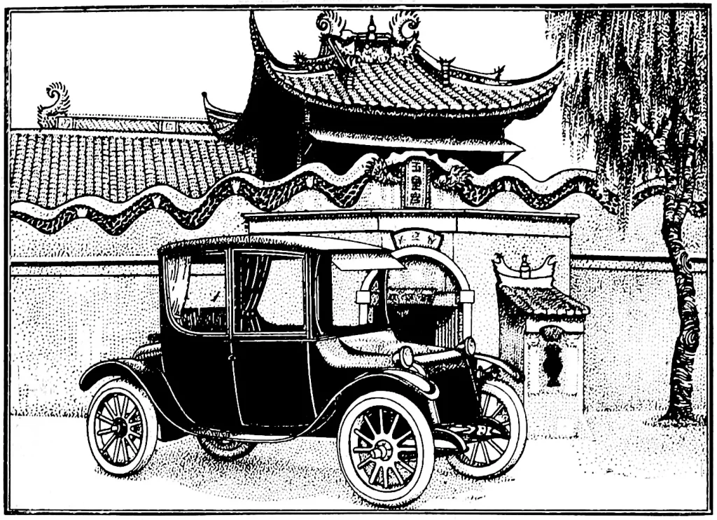 An antique Milburn Electric car parked on a sunny street.