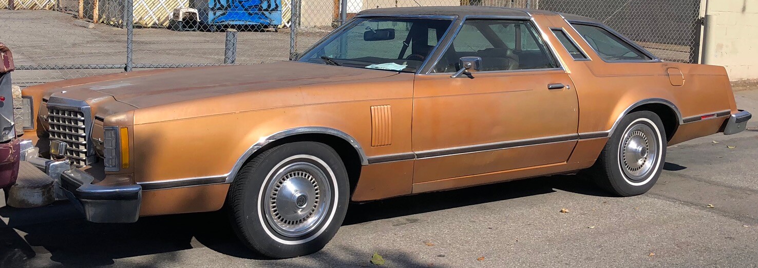 Crimson red 1980 Ford Thunderbird parked on a sunny street