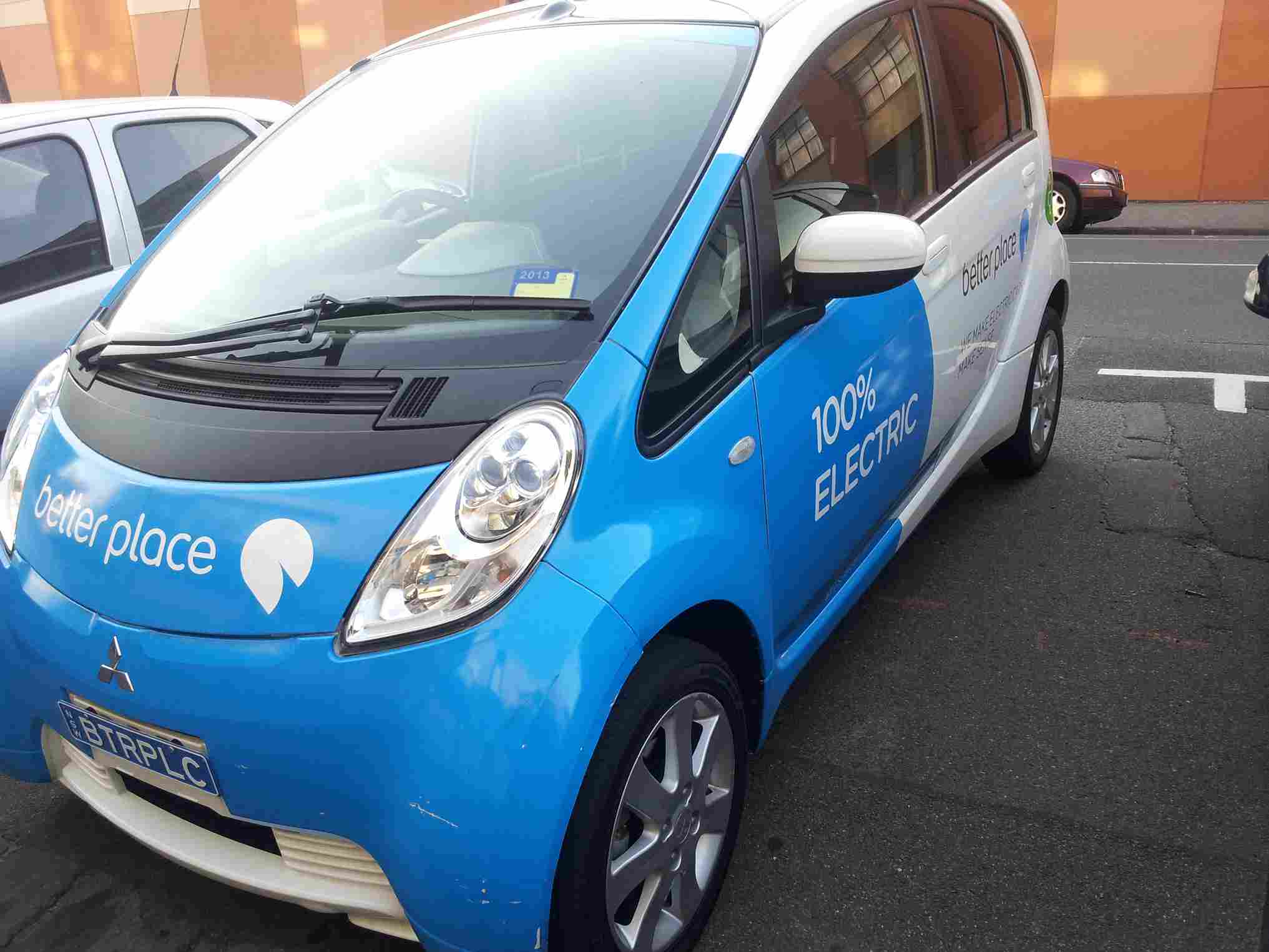 Wide shot of the Better Place charging station, electric vehicles plugged in.