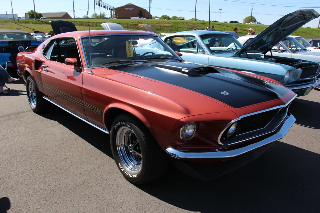 Red 1969 Ford Mustang Mach 1 Sportsroof, classic American muscle car.

