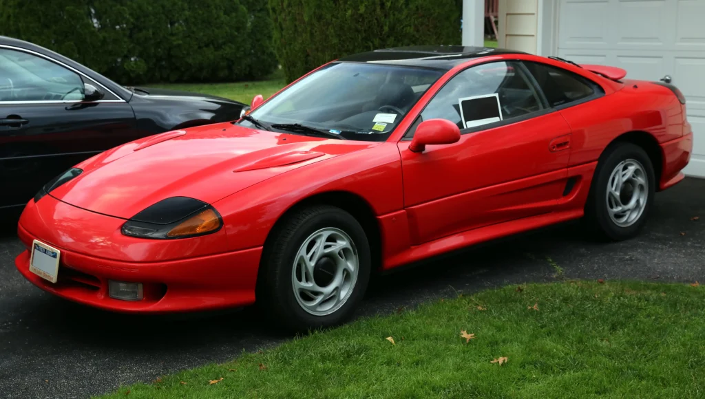 Bright red 1991 Dodge Stealth RT, front left view, parked outdoors.

