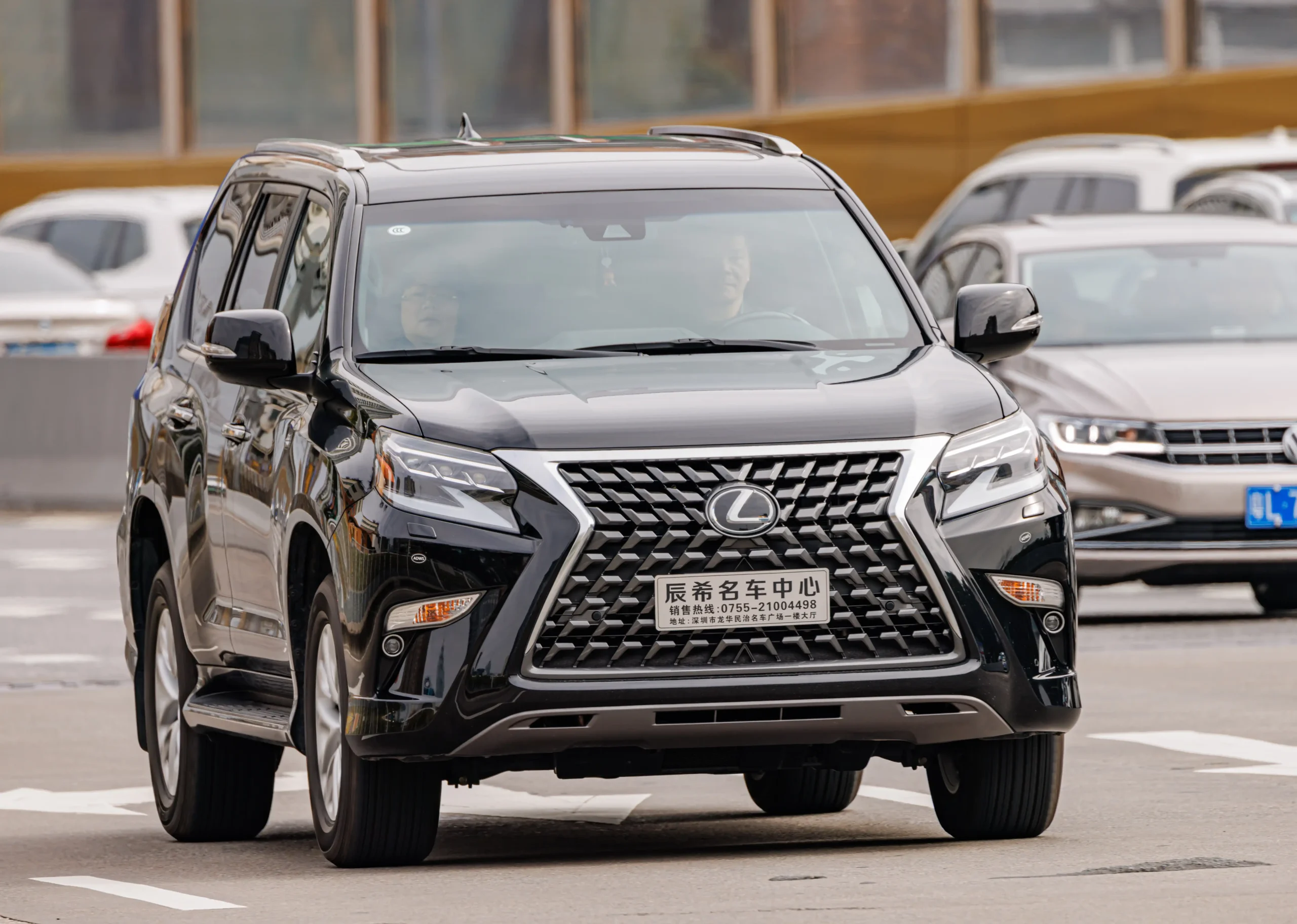 Silver Lexus GX driving on a winding mountain road.