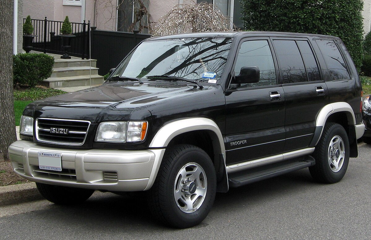 The Isuzu Trooper is a rugged, mid-size SUV, renowned for its off-road capabilities, durable build, and spacious interior, making it a great choice for both adventure and utility.