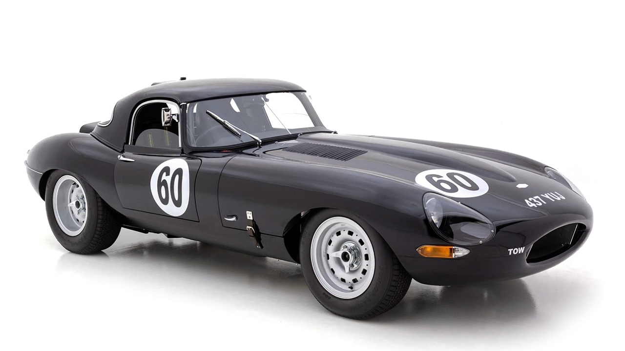 Classic racing car in dark gray/black, featuring number 60, vintage racing design with exposed wheels. Clean studio background highlighting sleek automotive silhouette of a legendary sports car