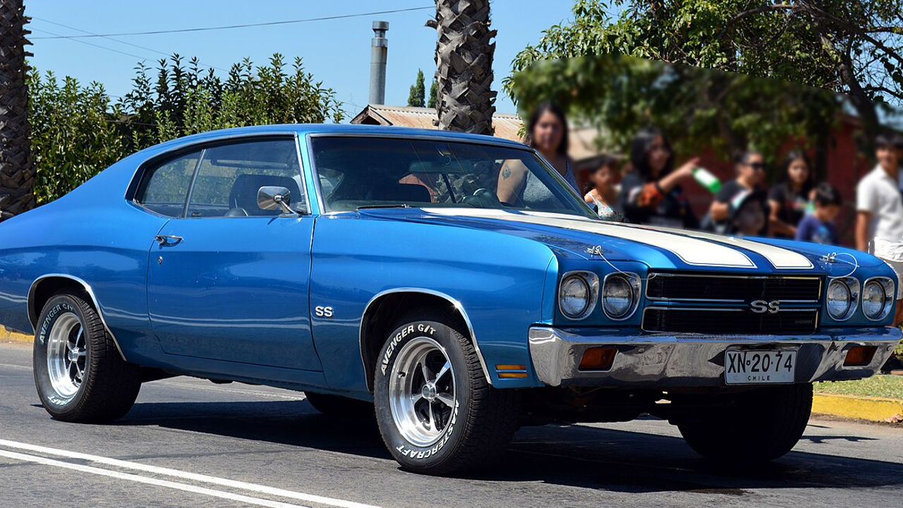Bright blue 1970 Chevrolet Chevelle SS 454 muscle car with white racing stripes on suburban street