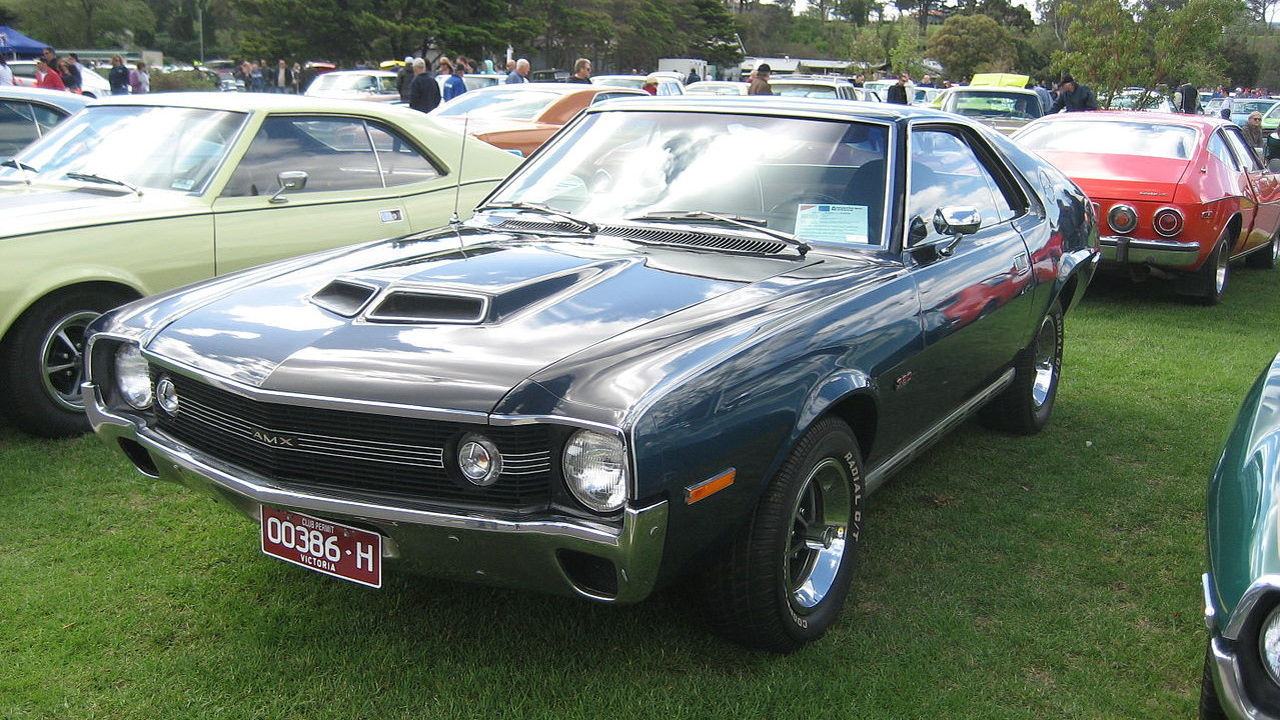 Black 1970 AMC Javelin AMX muscle car with hood scoops displayed at outdoor classic car show
