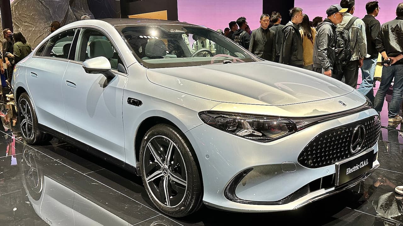 2025 Mercedes-Benz CLA displayed at auto show with distinctive diamond grille and crowds viewing
