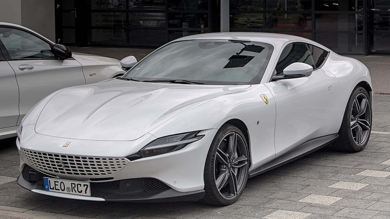 Ferrari Roma with distinctive mesh grille, sleek profile, and sporty alloy wheels parked on street