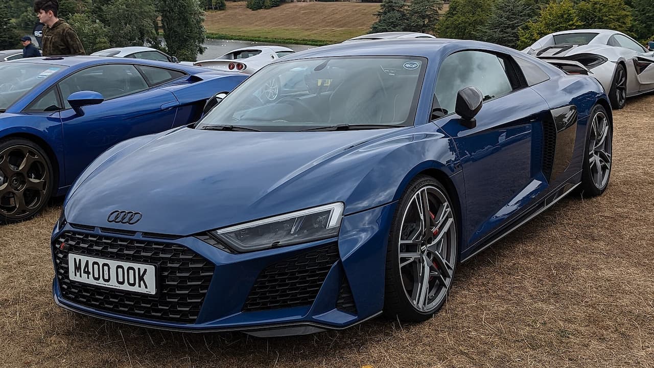 Blue Audi R8 V10 Performance with license plate M400 OOK parked at outdoor car gathering event