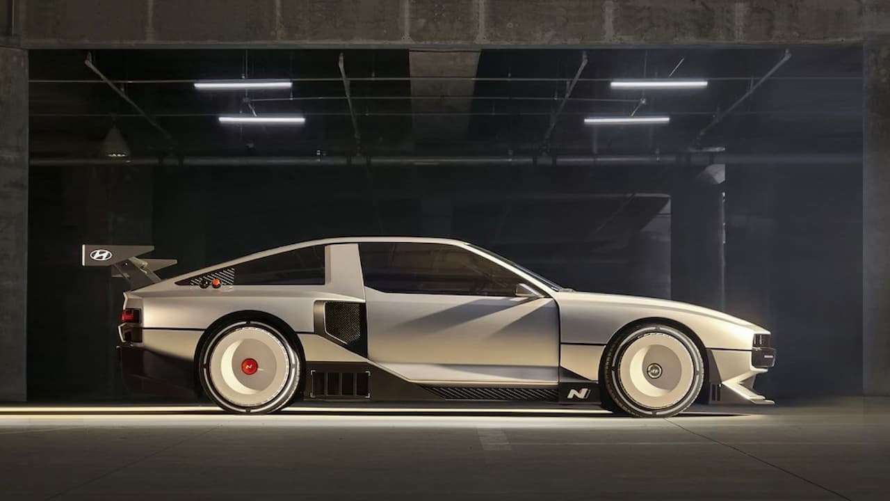 Silver Hyundai electric concept car with angular design and distinctive wheels in modern industrial garage setting