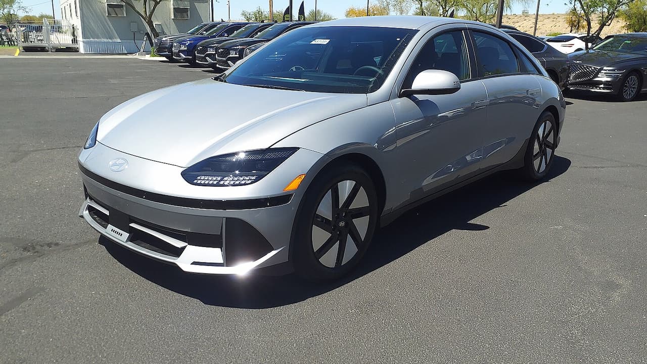 Silver Hyundai Ioniq 6 SE Long Range RWD electric vehicle with streamlined design and aerodynamic wheels parked in dealership lot