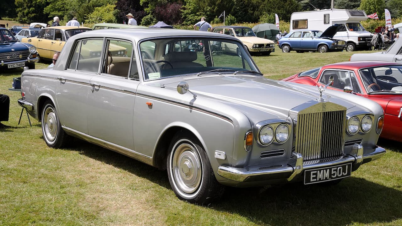 Silver Rolls-Royce Silver Shadow with iconic grille and Spirit of Ecstasy ornament at classic car show