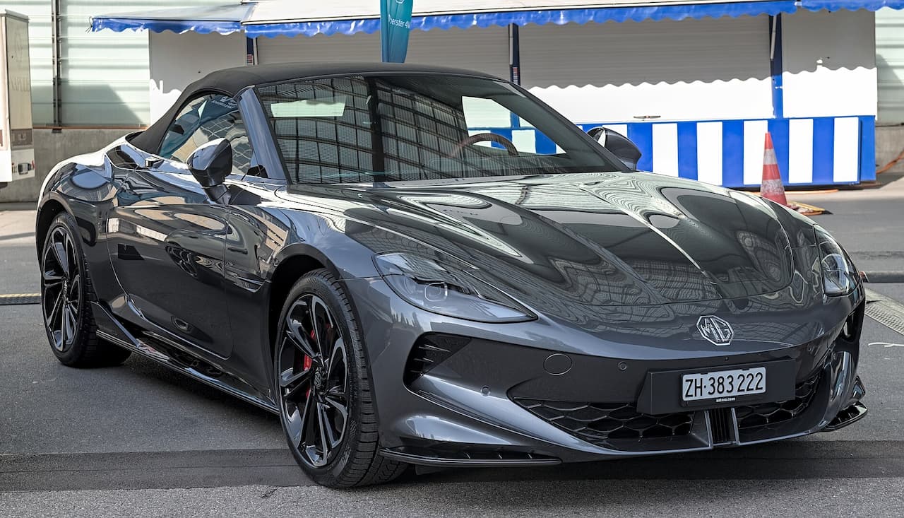 Dark gray MG Cyberster sports car with black wheels parked in covered parking garage with Swiss license plate